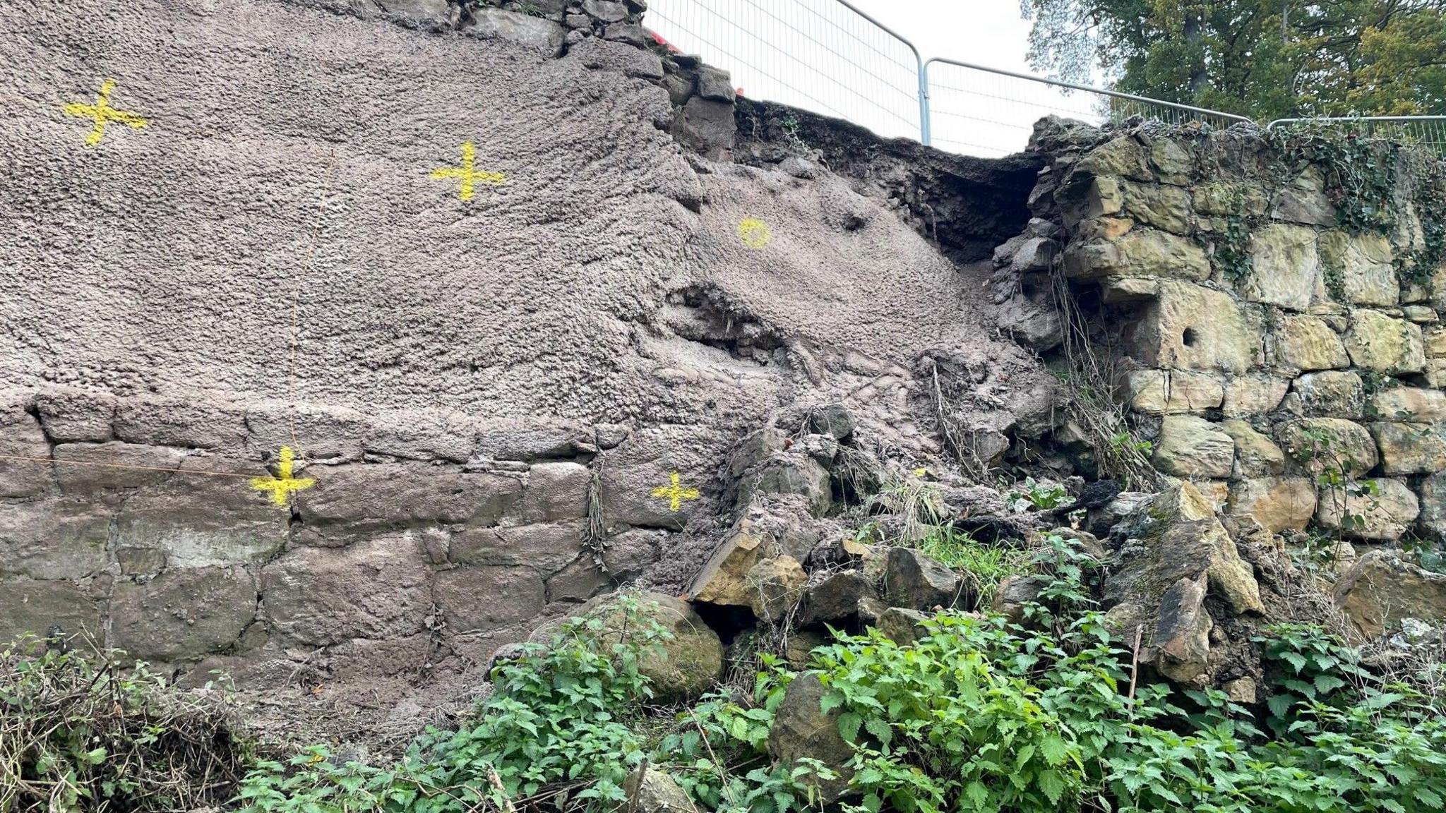 Yellow crosses on the wall to mark drilling spots