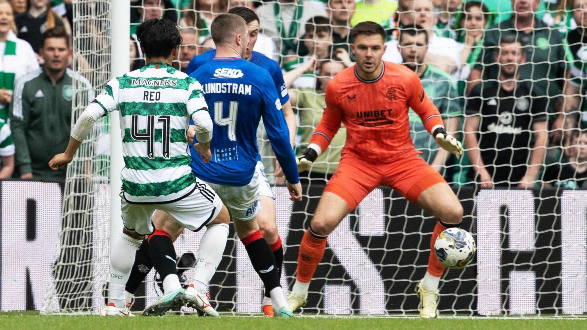 Rangers' John Lundstram scores an own goal in a match against Celtic