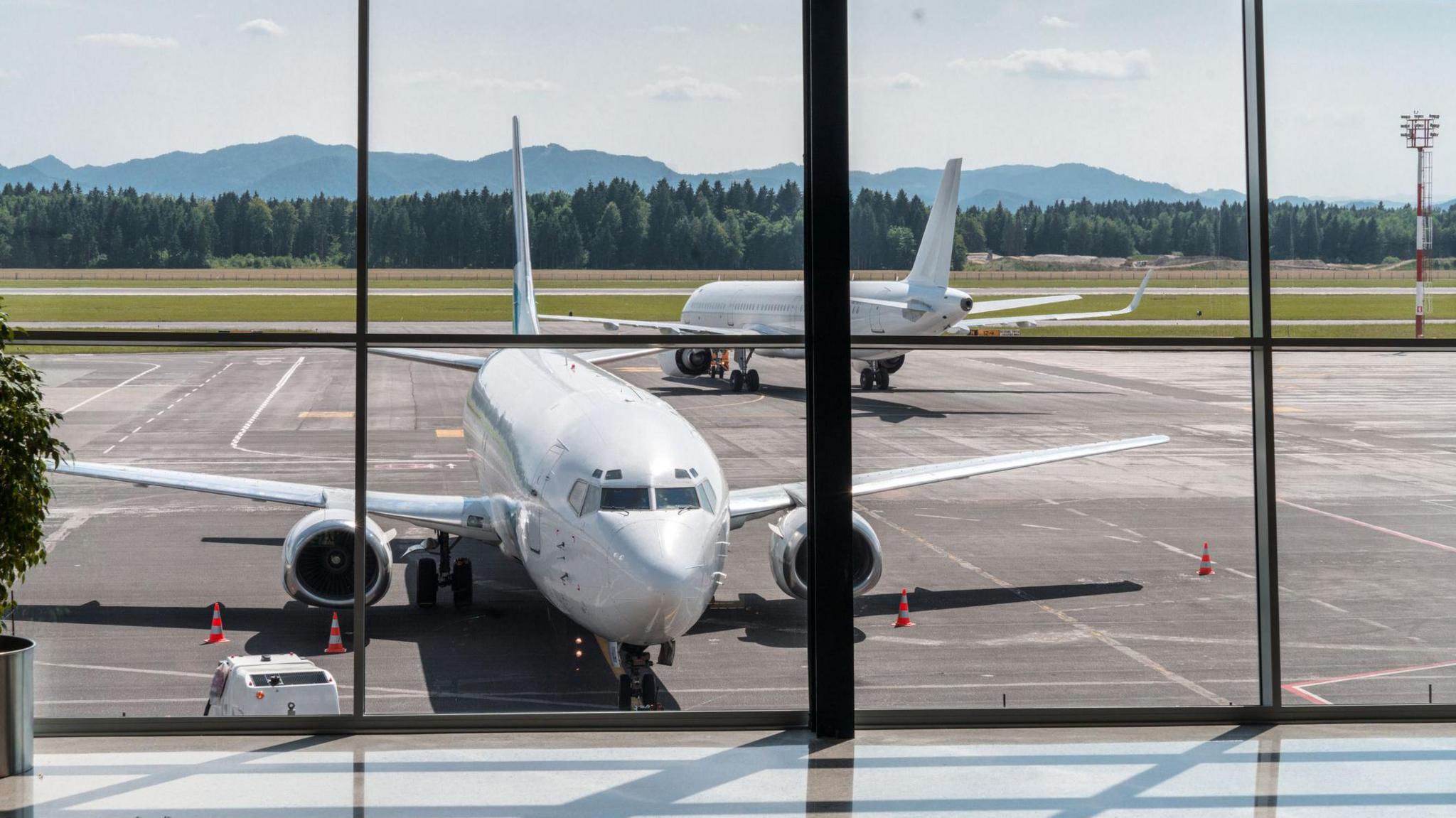 Two planes parked on a runway