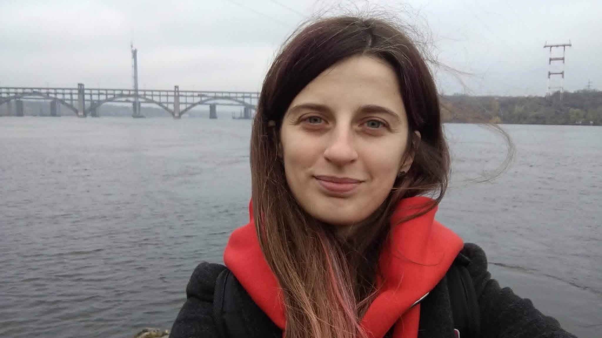 Anna Holovchenko stands in front of the Preobrazhensky Bridge in her home city of Zaporizhzhia