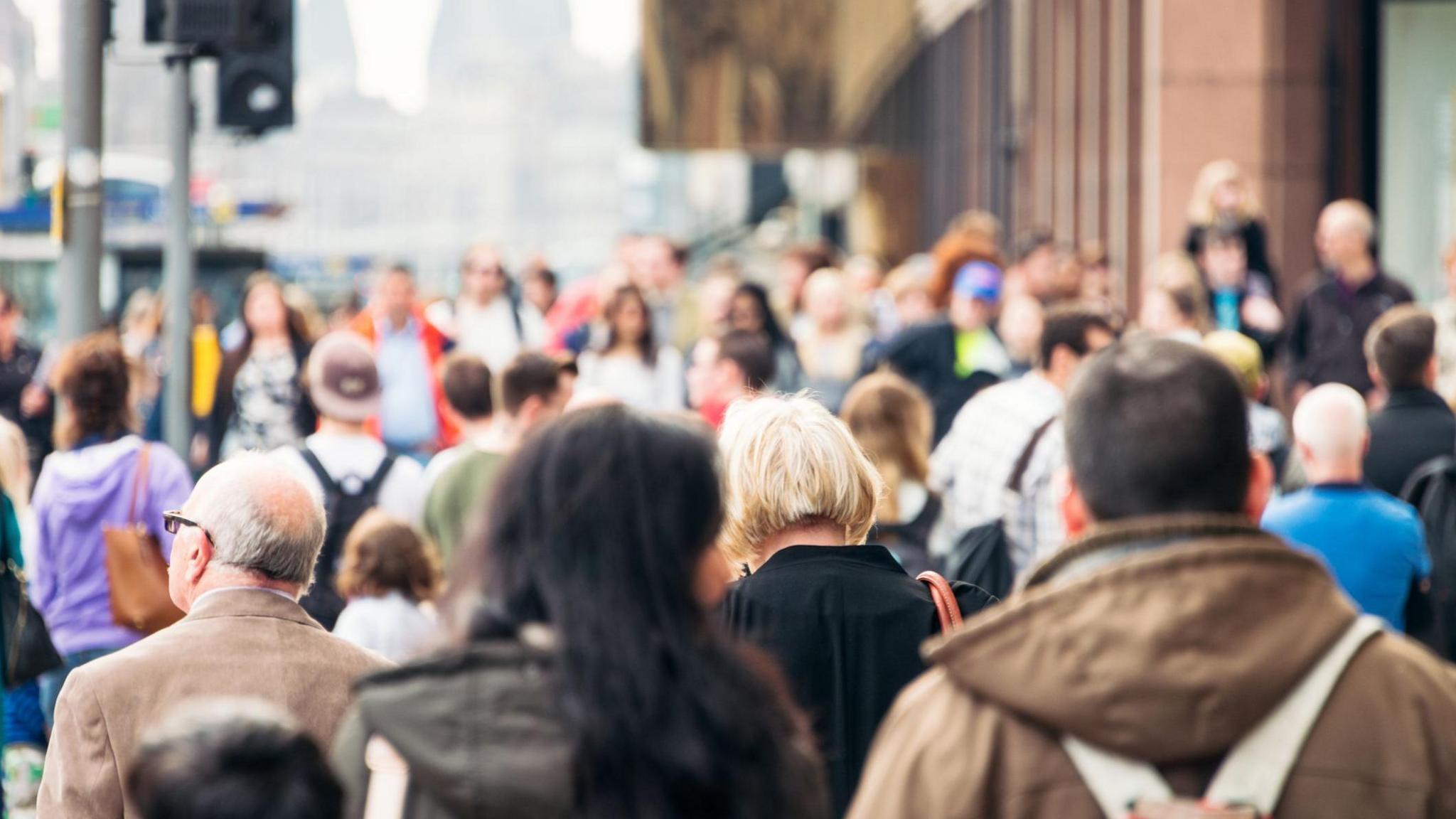 An image of many people walking down a busy high street