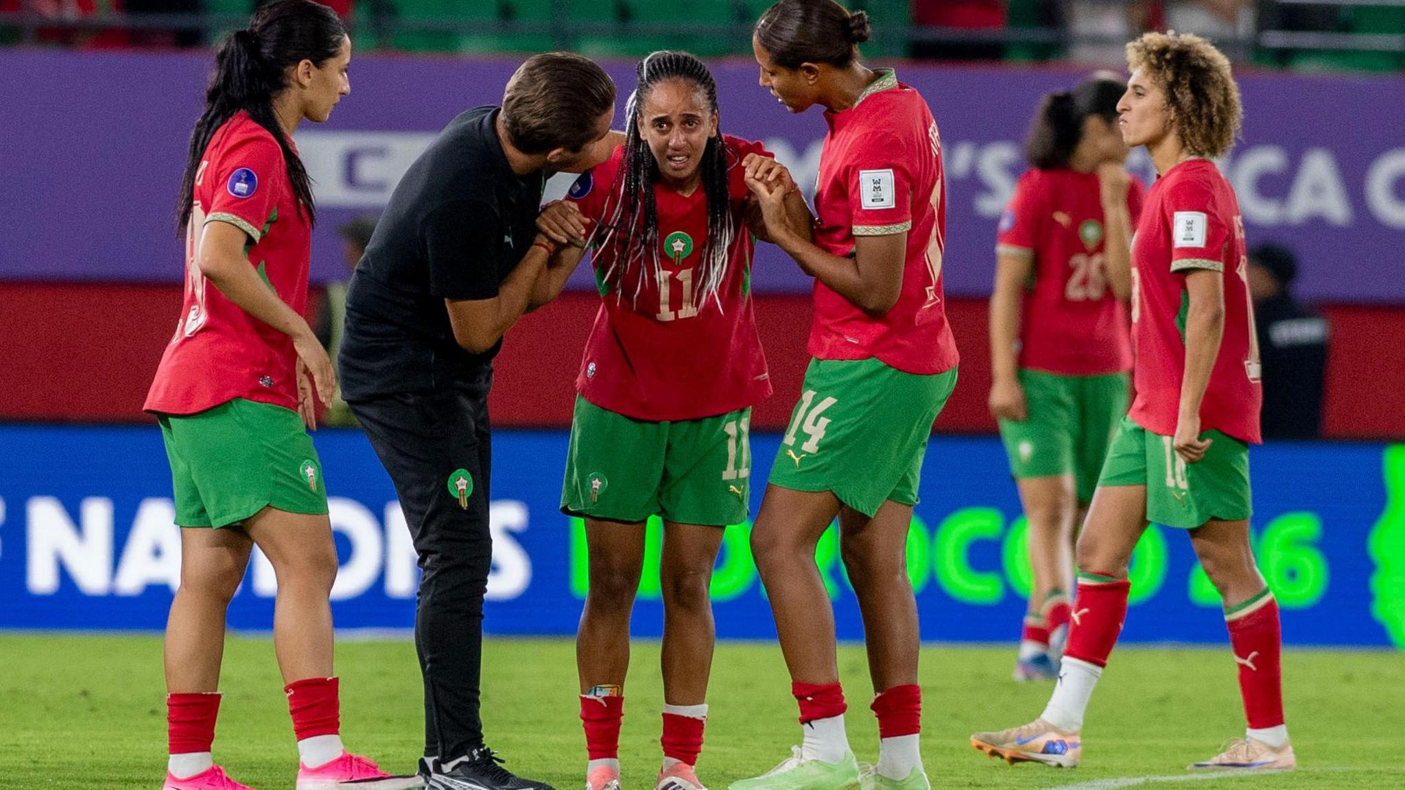 Morocco staff and players console Fatima Tagnaout after she missed a penalty in the Women's Africa Cup of Nations semi-final defeat