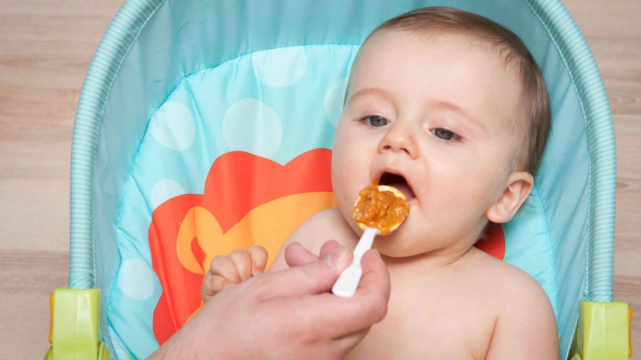 A baby being fed