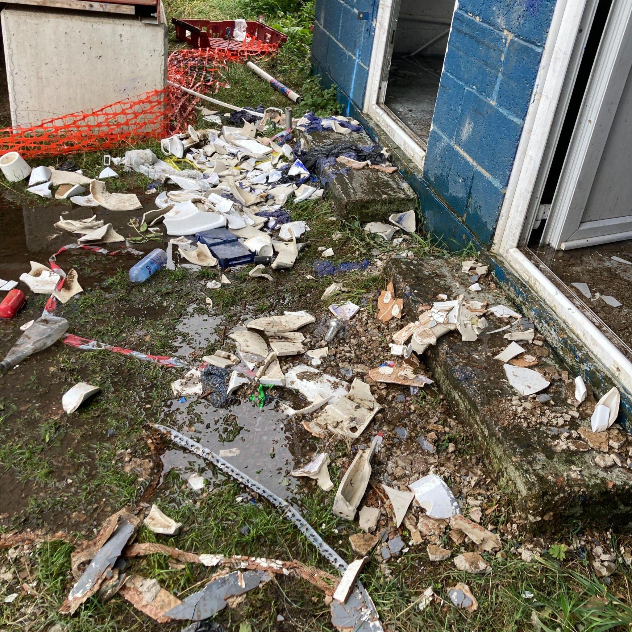 Porcelain and other debris strewn across the floor at the ground