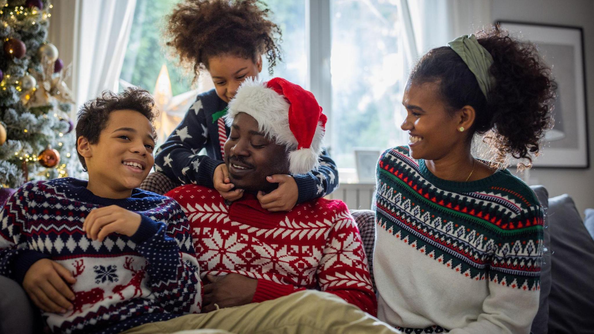 family in Xmas jumpers