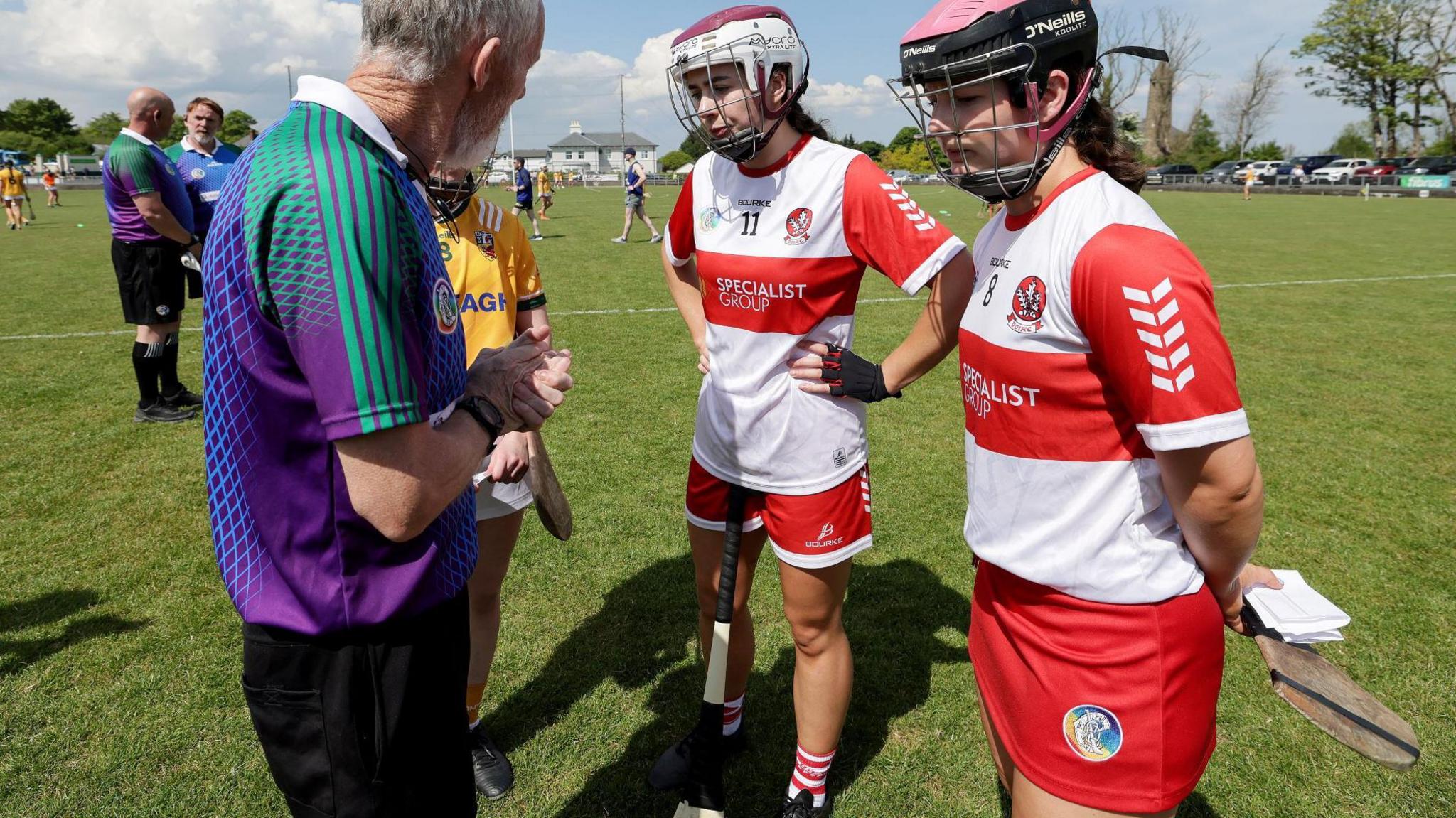 Referee Philip McDonald reminds Derry joint-captain Rachel McAllister that the Oak Leafers would have to play the game in skorts as opposed to shorts