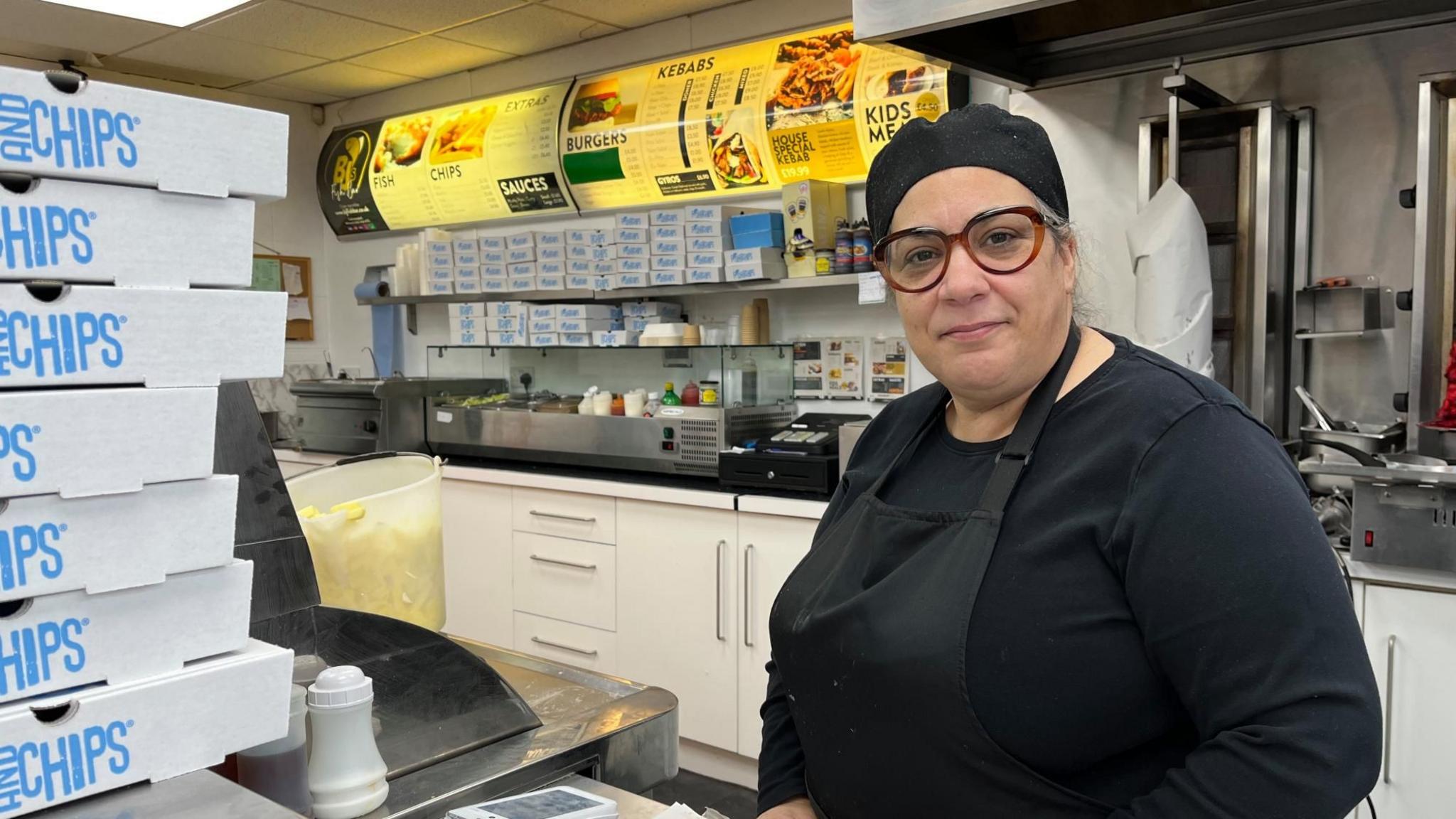 Niki Papa stood inside her chip shop in Burton Joyce.