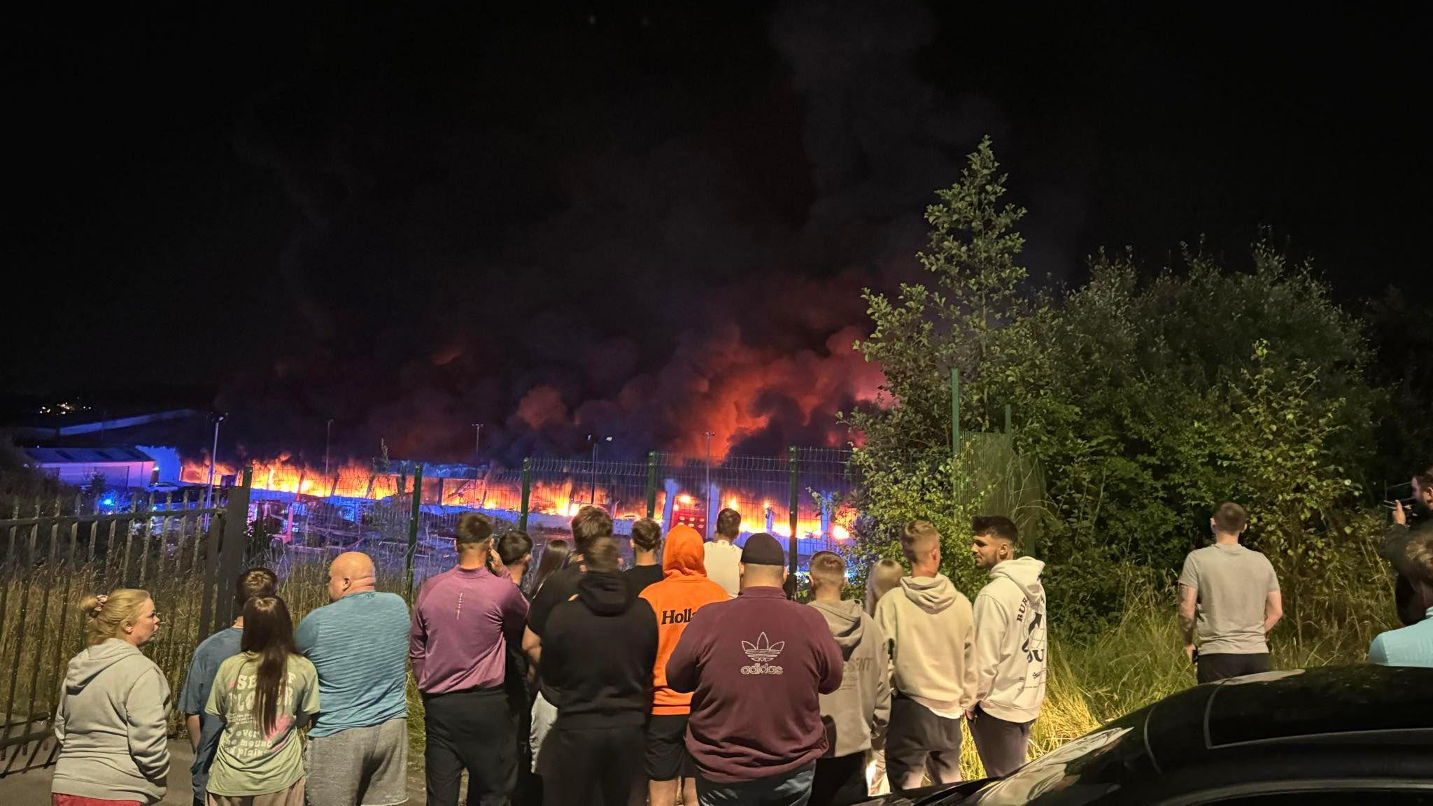 Picture of residents gathered watching the fire at Tarfarnaubach Industrial Estate