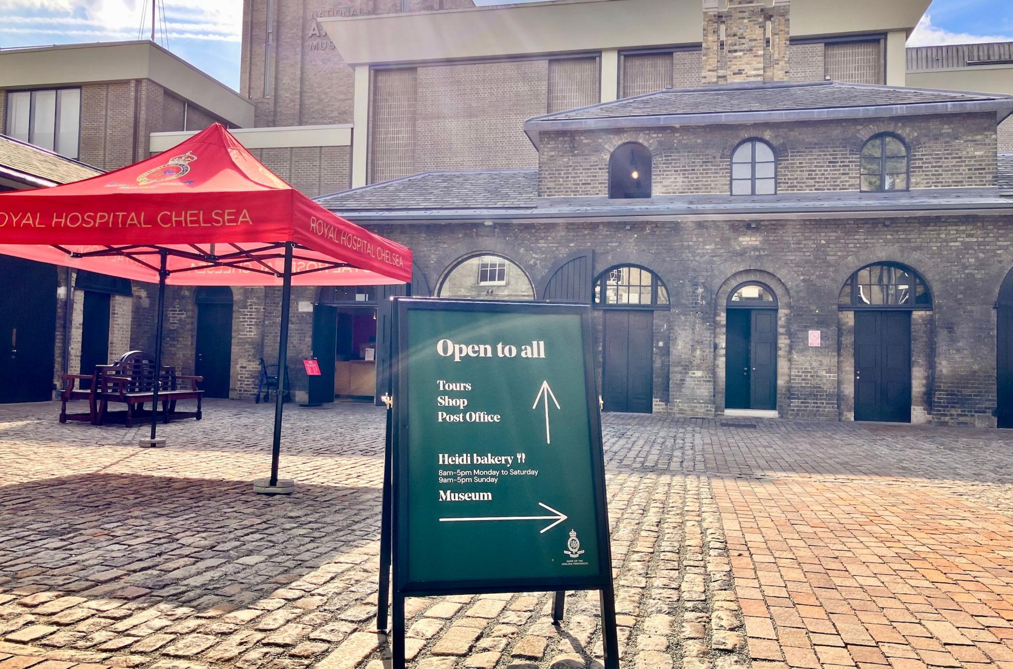 sign  outside yard on cobbled stones