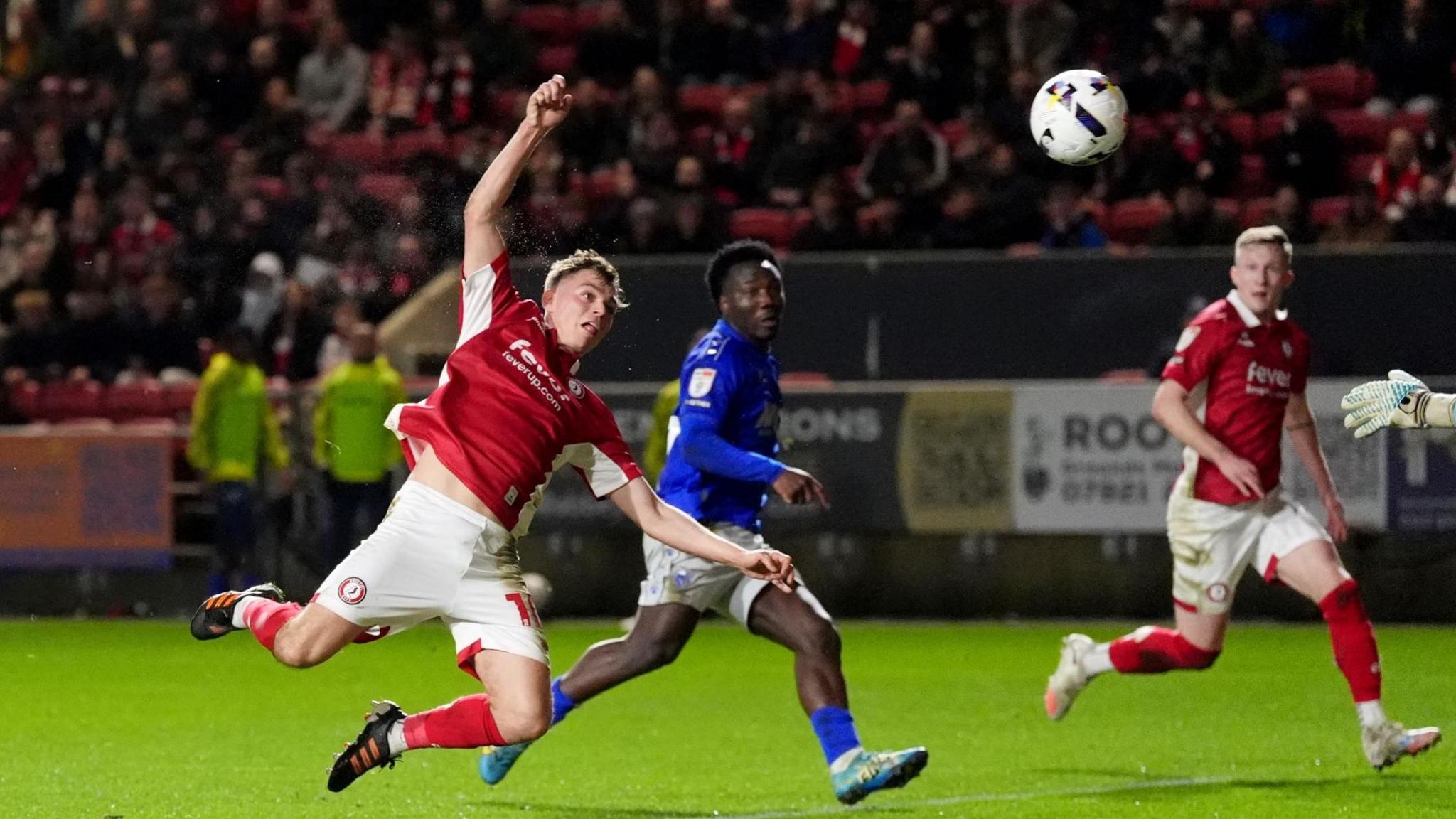 Scott Twine (left) flies towards the floor and watches as the ball drifts through the air before going into the net