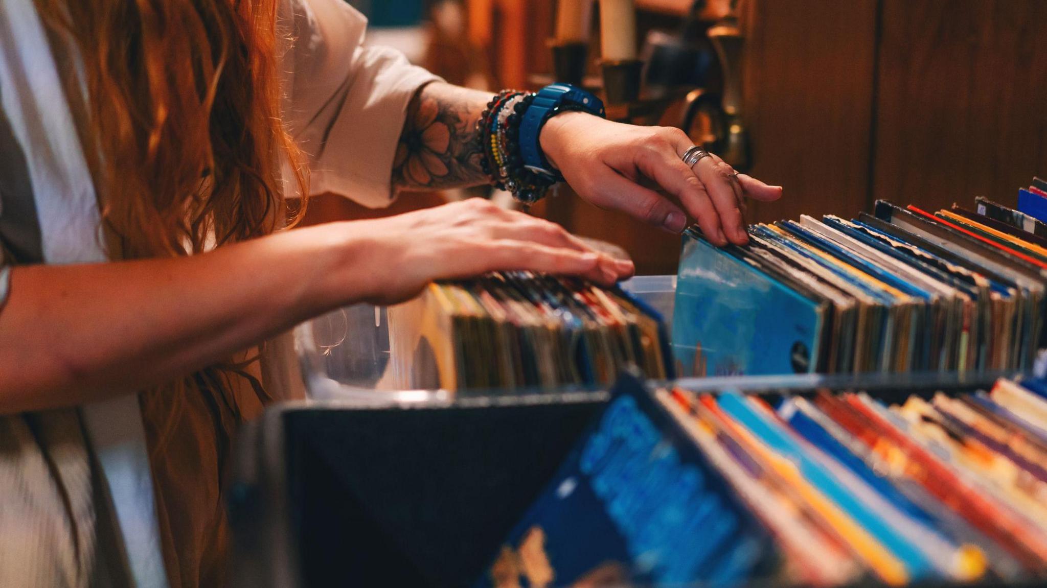 Close up shot of an unrecognisable woman browsing in a vintage shop