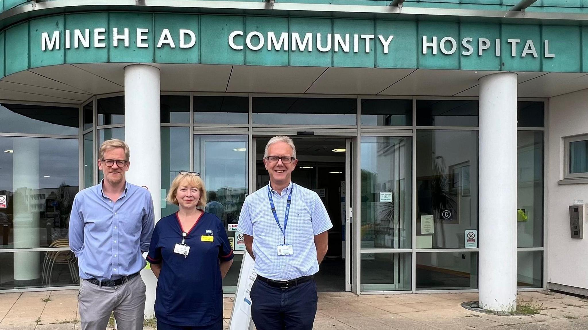 Three representatives from Somerset NHS Foundation Trust stand outside Minehead Community Hospital.