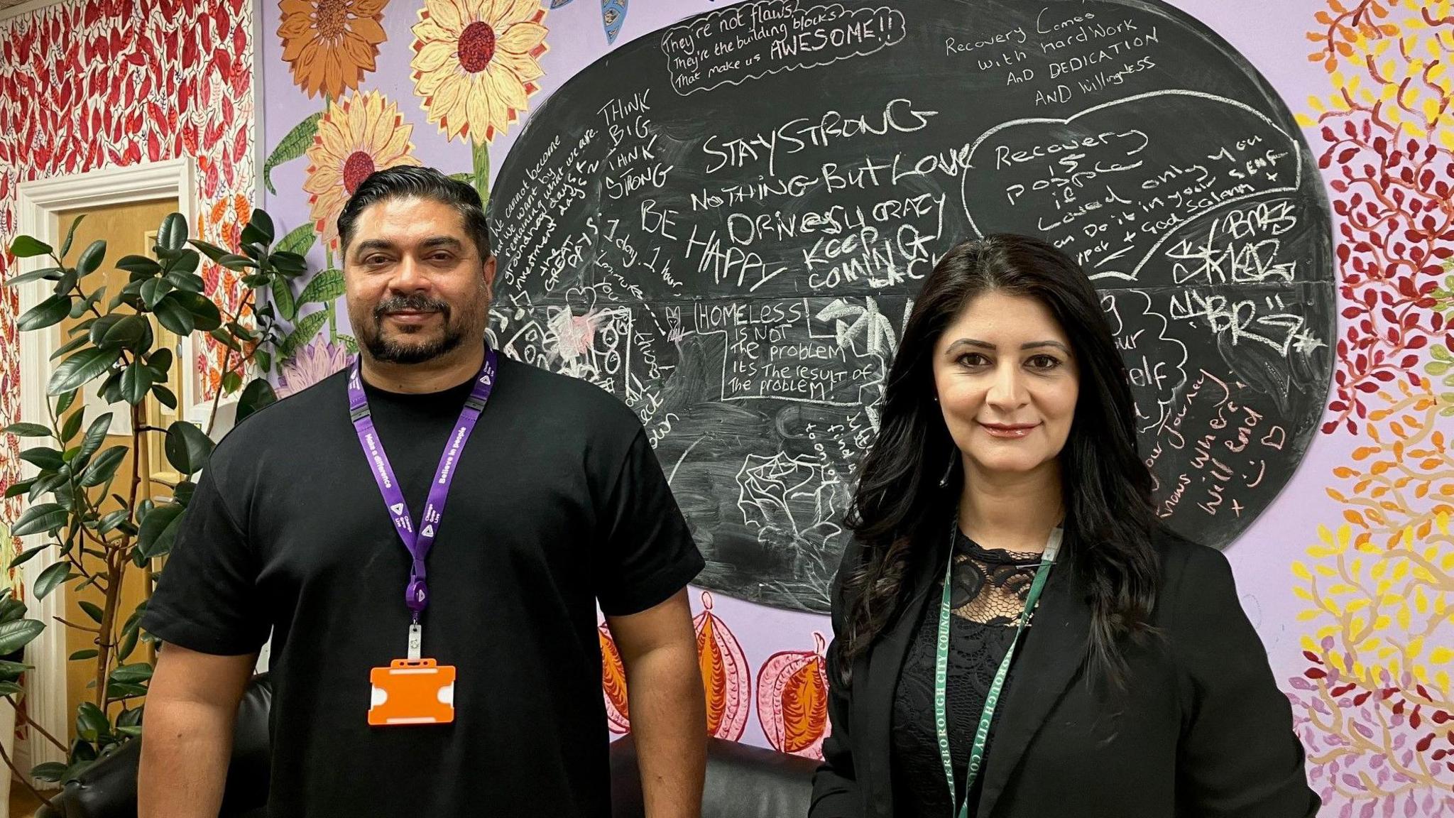 Raja Alyas in a black T-shirt and Dr Shabina Qayyum in a black jacket smiling at the camera