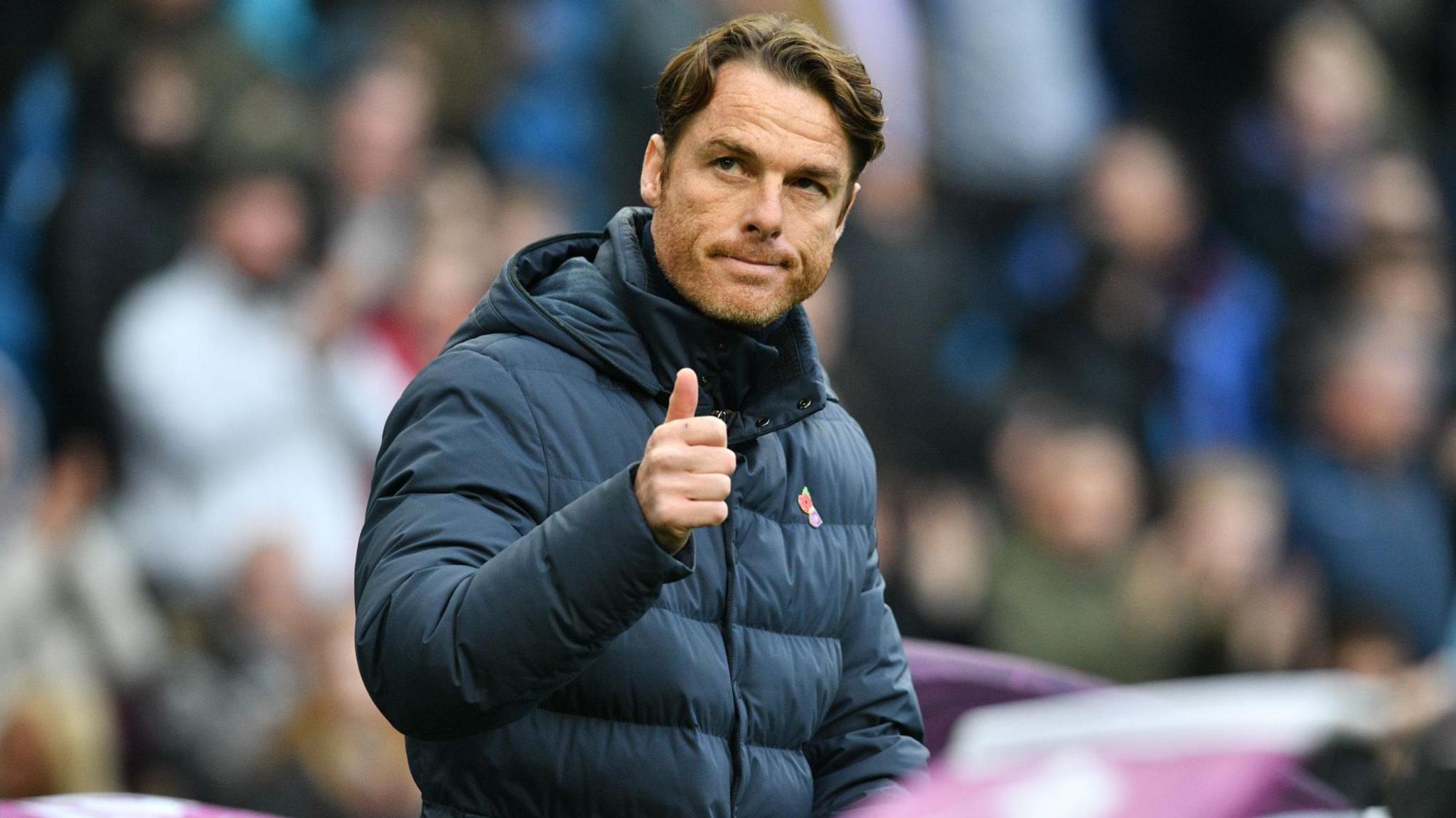 Burnley manager Scott Parker gives the thumbs-up to supporters