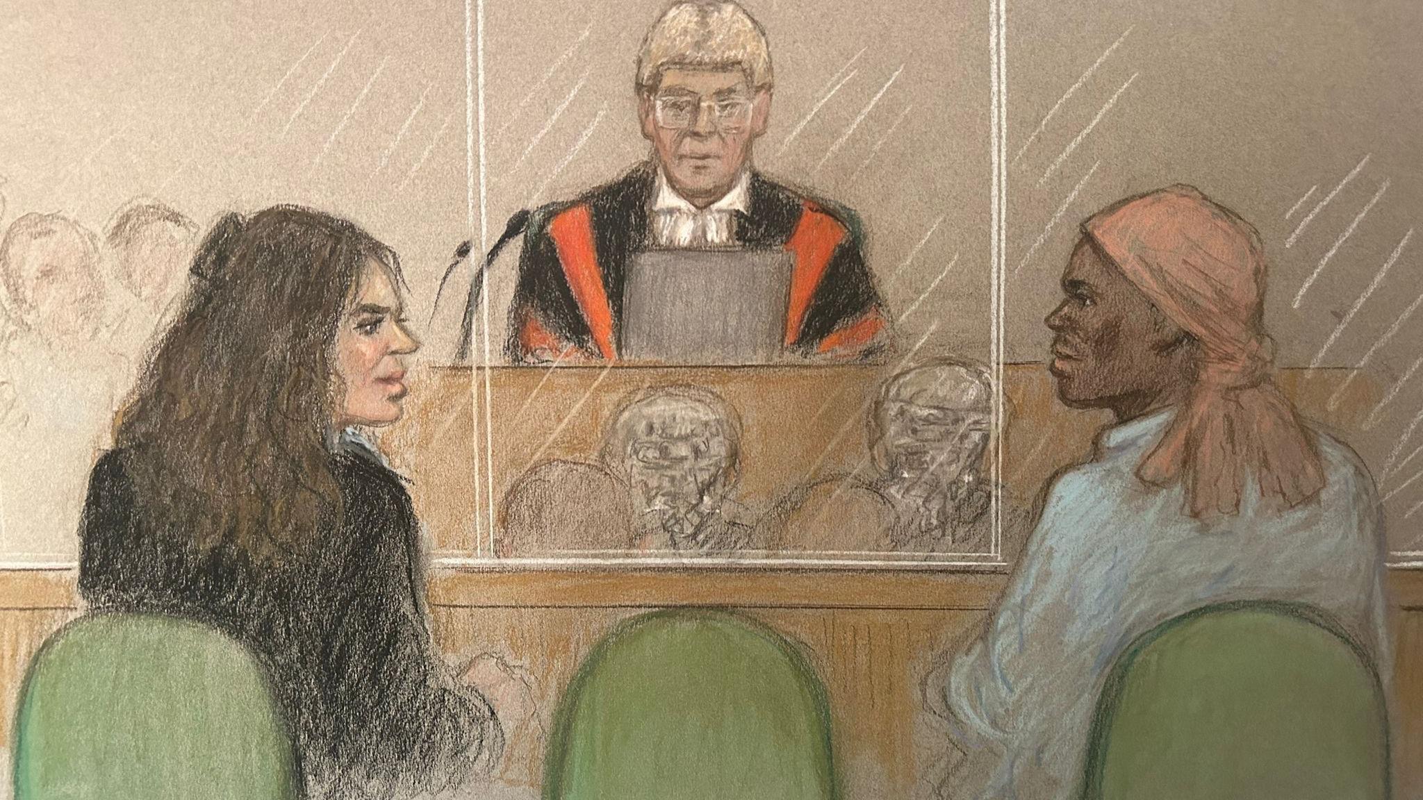 A court sketch showing Constance Marten, a woman with long brown hair wearing a dark top, and Mark Gordon, who has a peach-coloured headscarf and is wearing a shirt, looking at each other while sitting in a glass dock in court with the judge before them wearing a wig and red and black robes.
