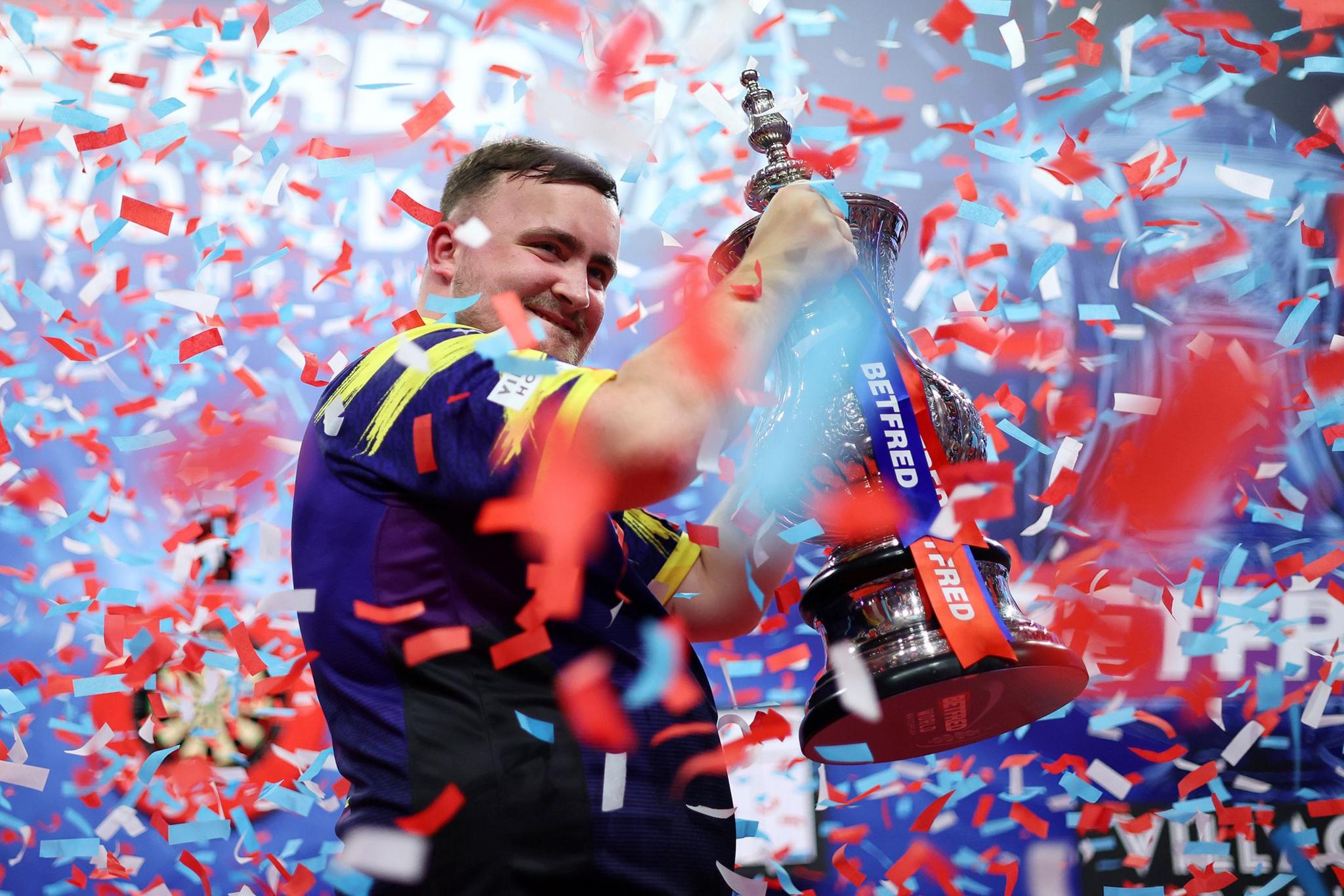 Luke Littler celebrates with The Phil Taylor Trophy after victory against James Wade at the World Matchplay at Winter Gardens in Blackpool. Photo by Lewis Storey
