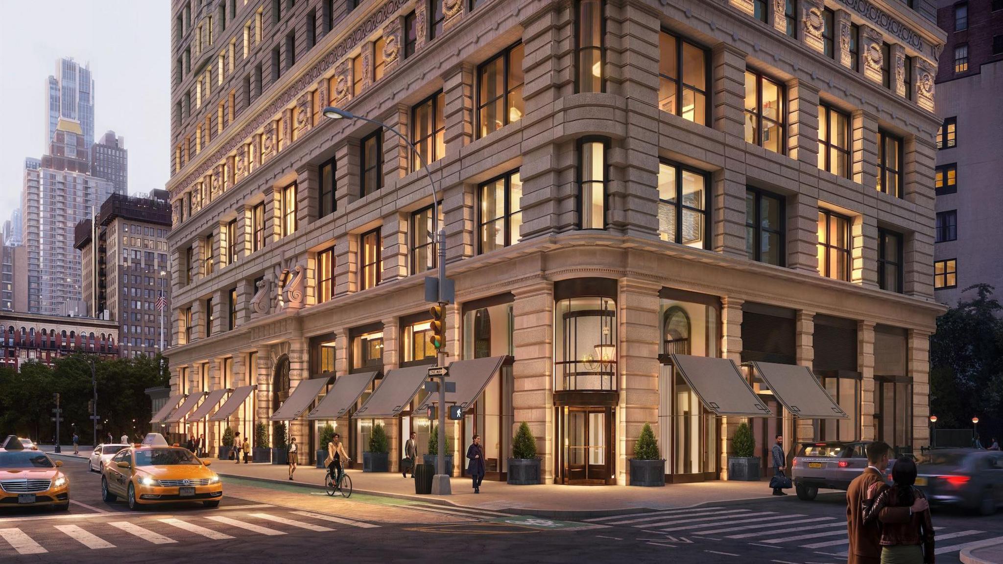 view of the front of Flatiron Building, outside lobby entrance, with vintage-style awnings over the windows