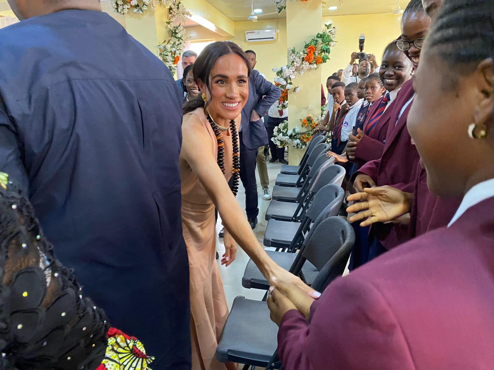 The Duchess of Sussex shaking hands with students at the Lightway Academy