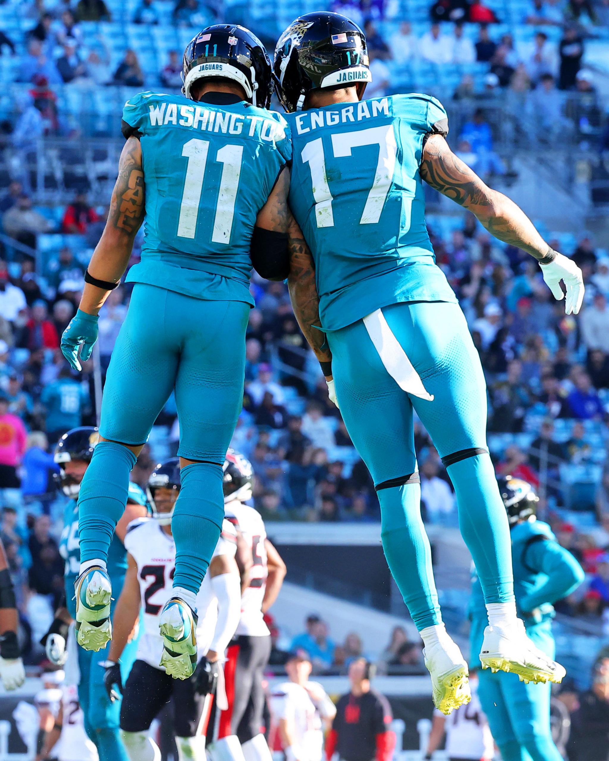 Parker Washington and Evan Engram of the Jacksonville Jaguars celebrate after Washington scored a fourth quarter touchdown against the Houston Texans at EverBank Stadium in Jacksonville, Florida.