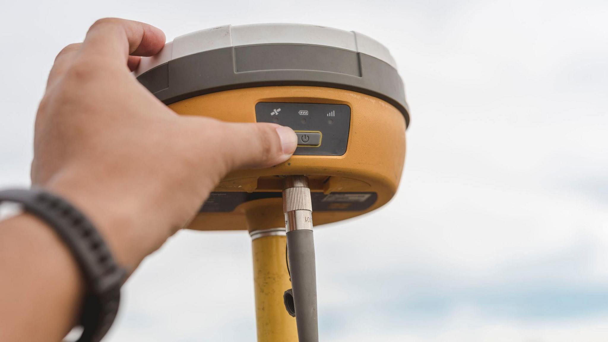 A surveyor sets up a Global Navigation Satellite System or GNSS Receiver.