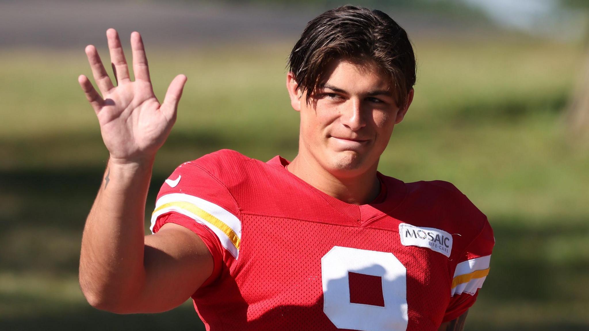 Louis Rees-Zammit waves to fans at training for Kansas City Chiefs