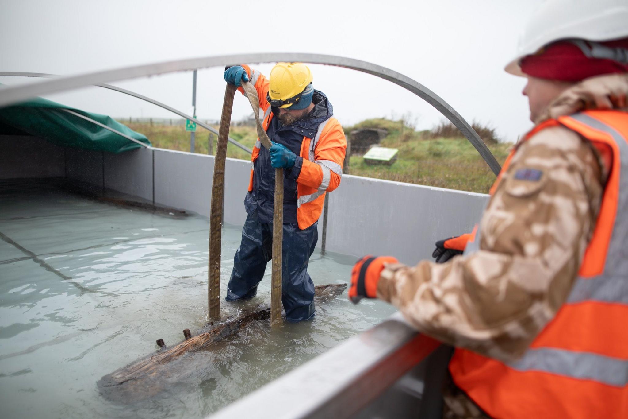 Ben Saunders, a senior marine archaeologist, moving the timber in the tank