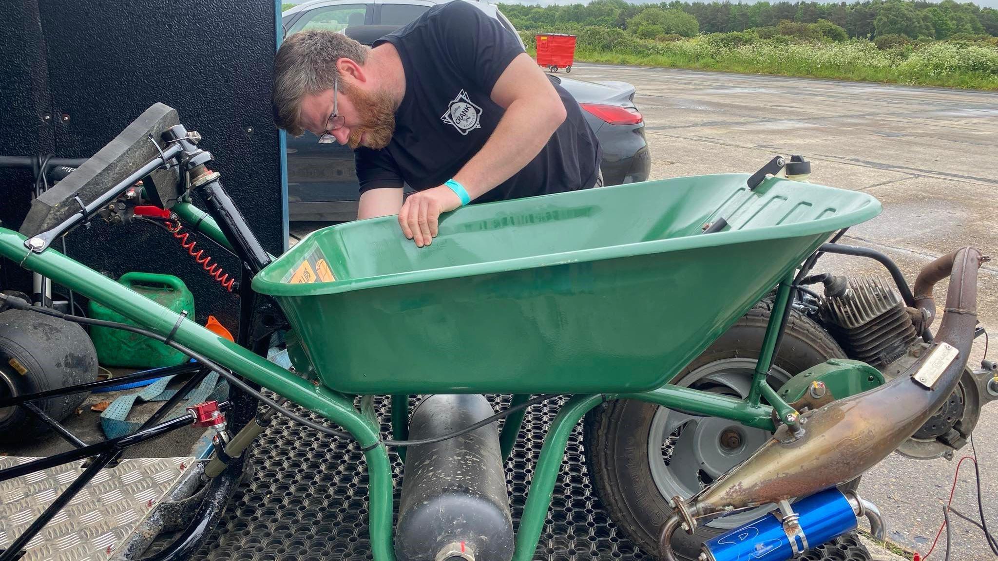 Dylan building the motorised wheelbarrow