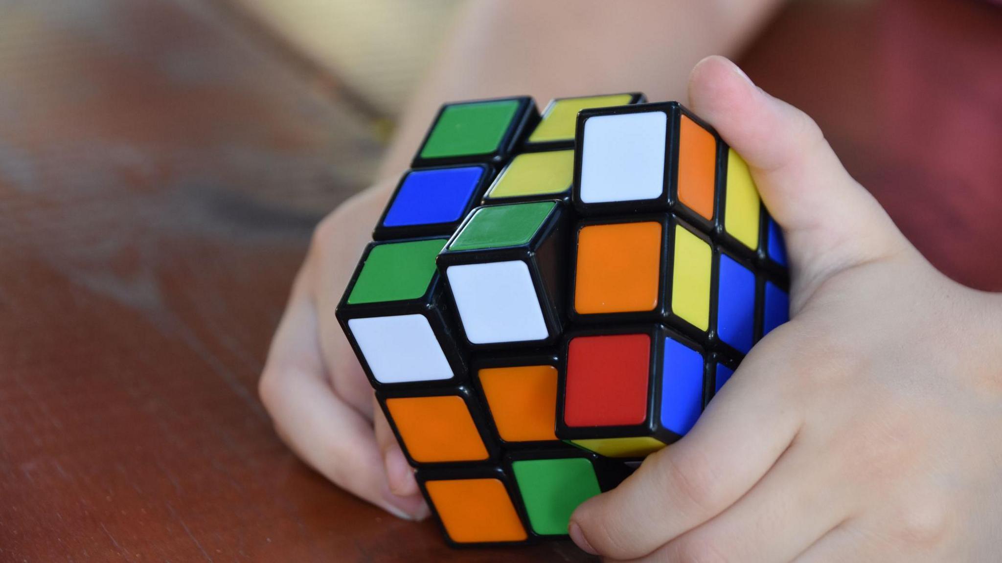 A child holding a Rubik's cube.