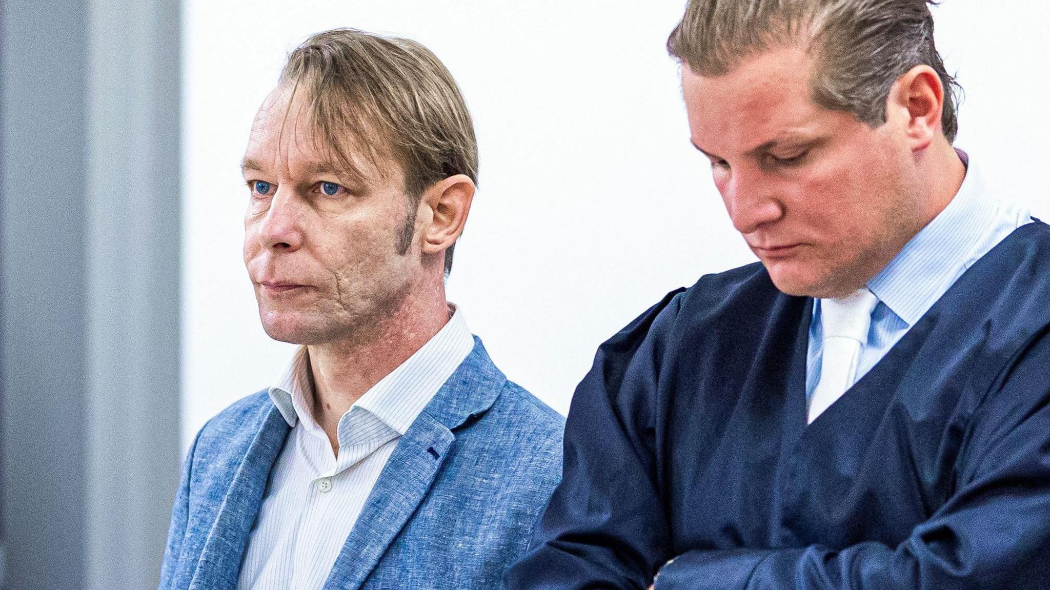 Christian Brückner stands beside his lawyer 