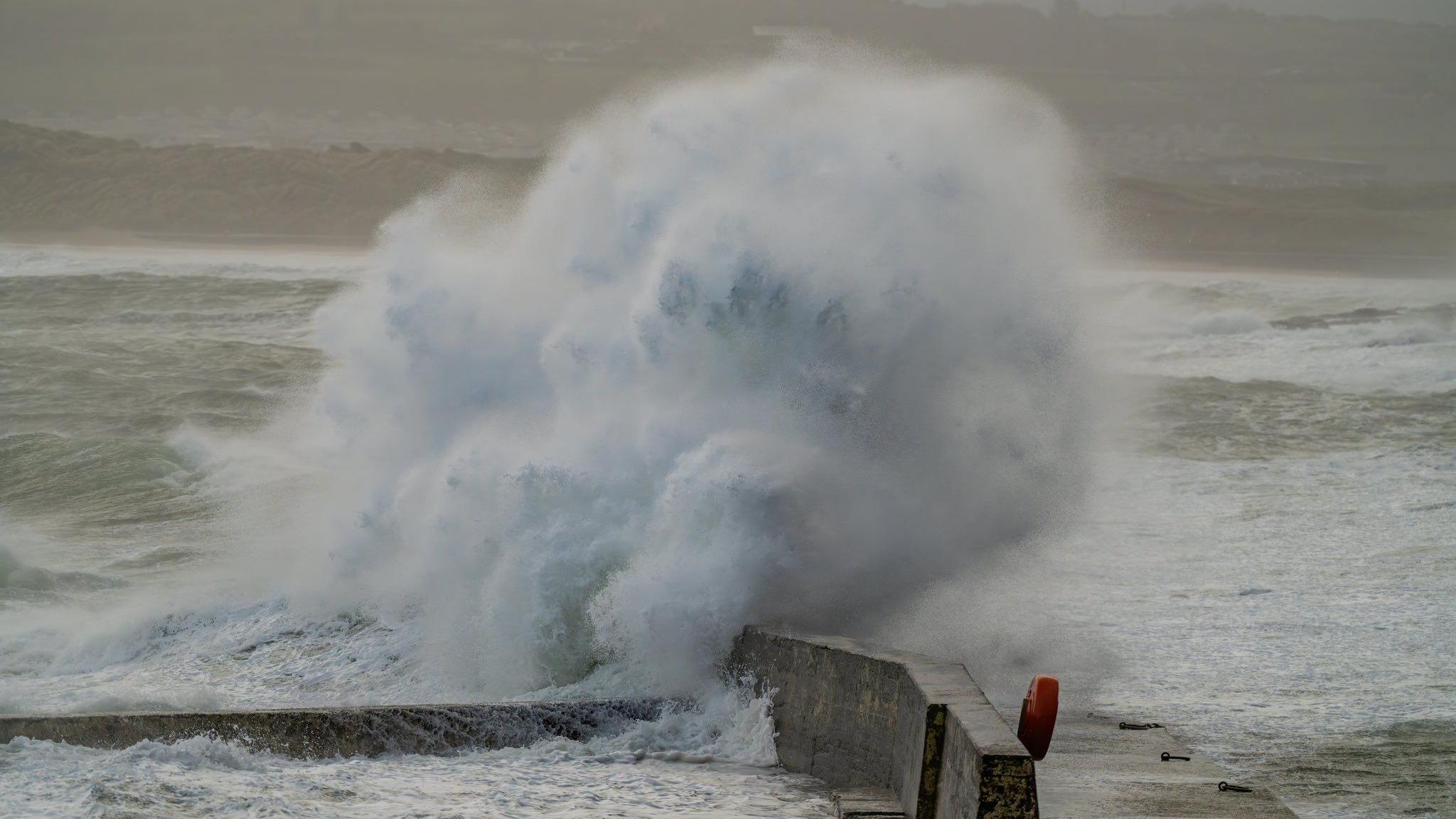 Large wave hitting against a wall in Portrush