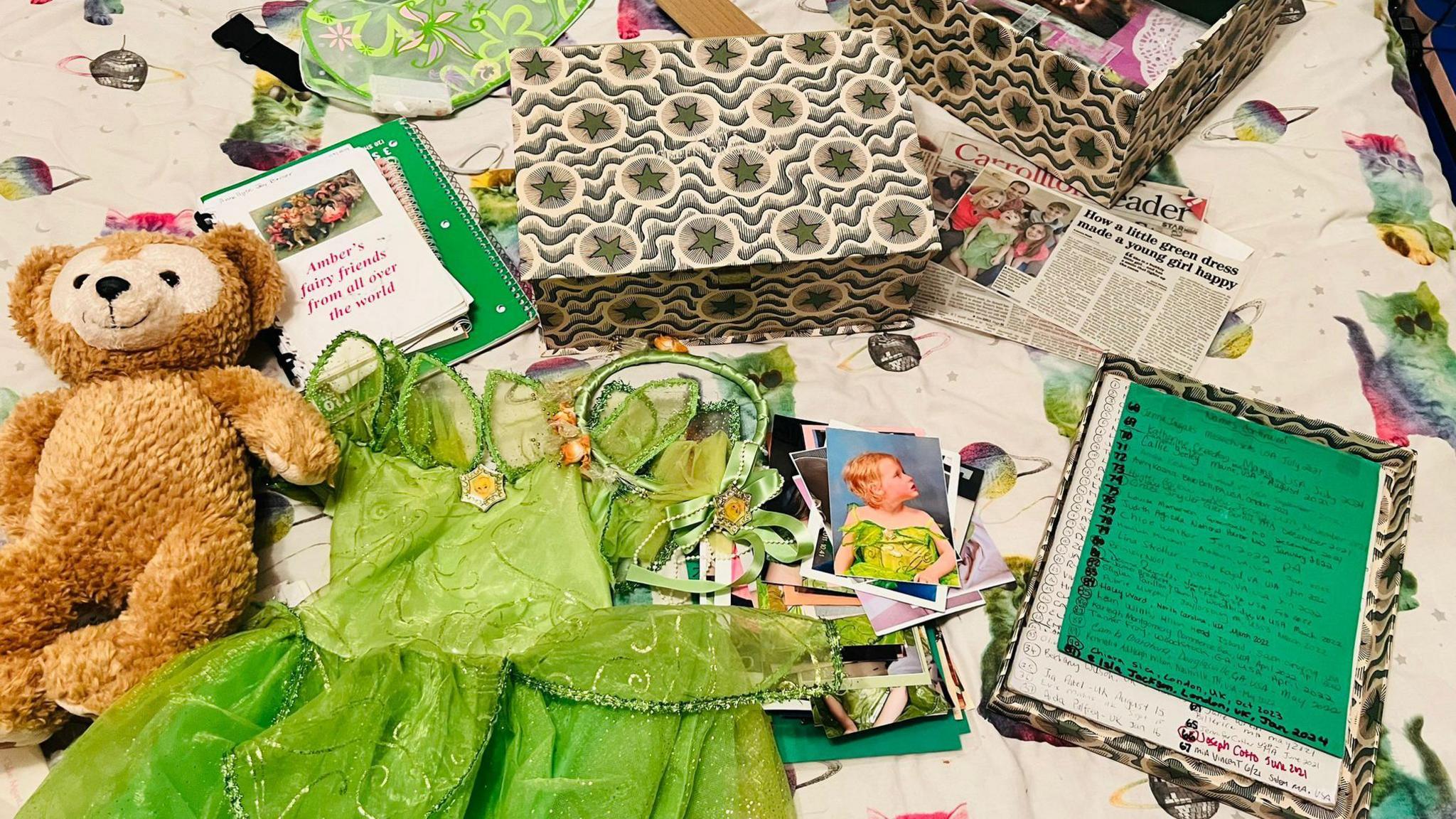 The green dress next to a bear, box and journal