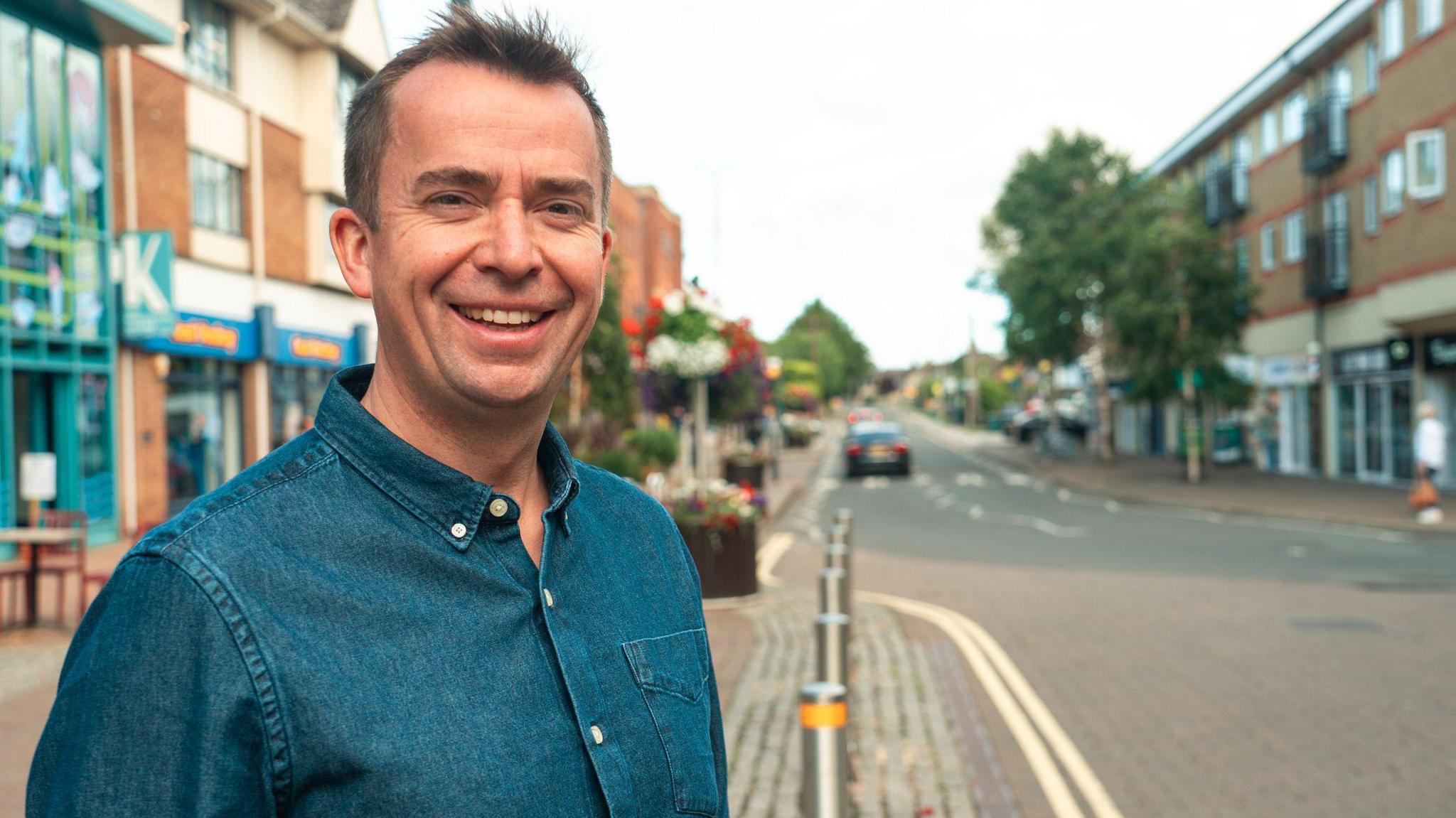 Stock image of Calum Miller in Kidlington. He has short brown hair and is wearing a blue denim shirt.