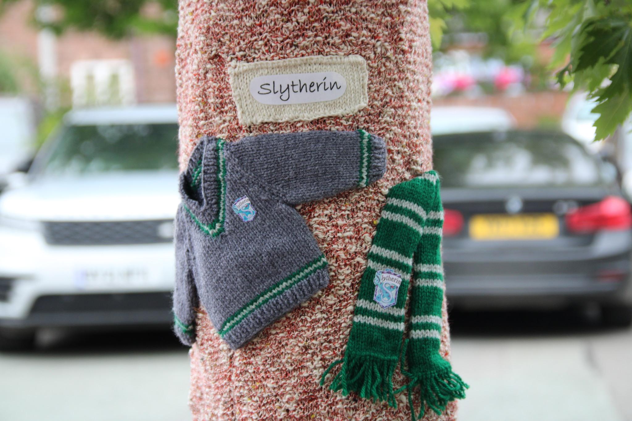 Knitted Slytherin outfit on a tree