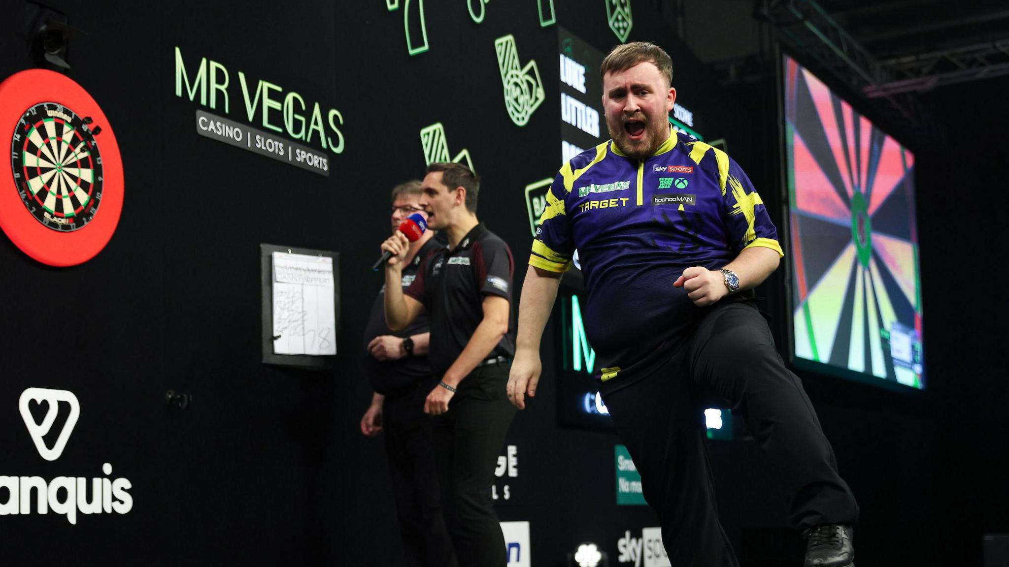 Luke Littler celebrates after becoming world number one