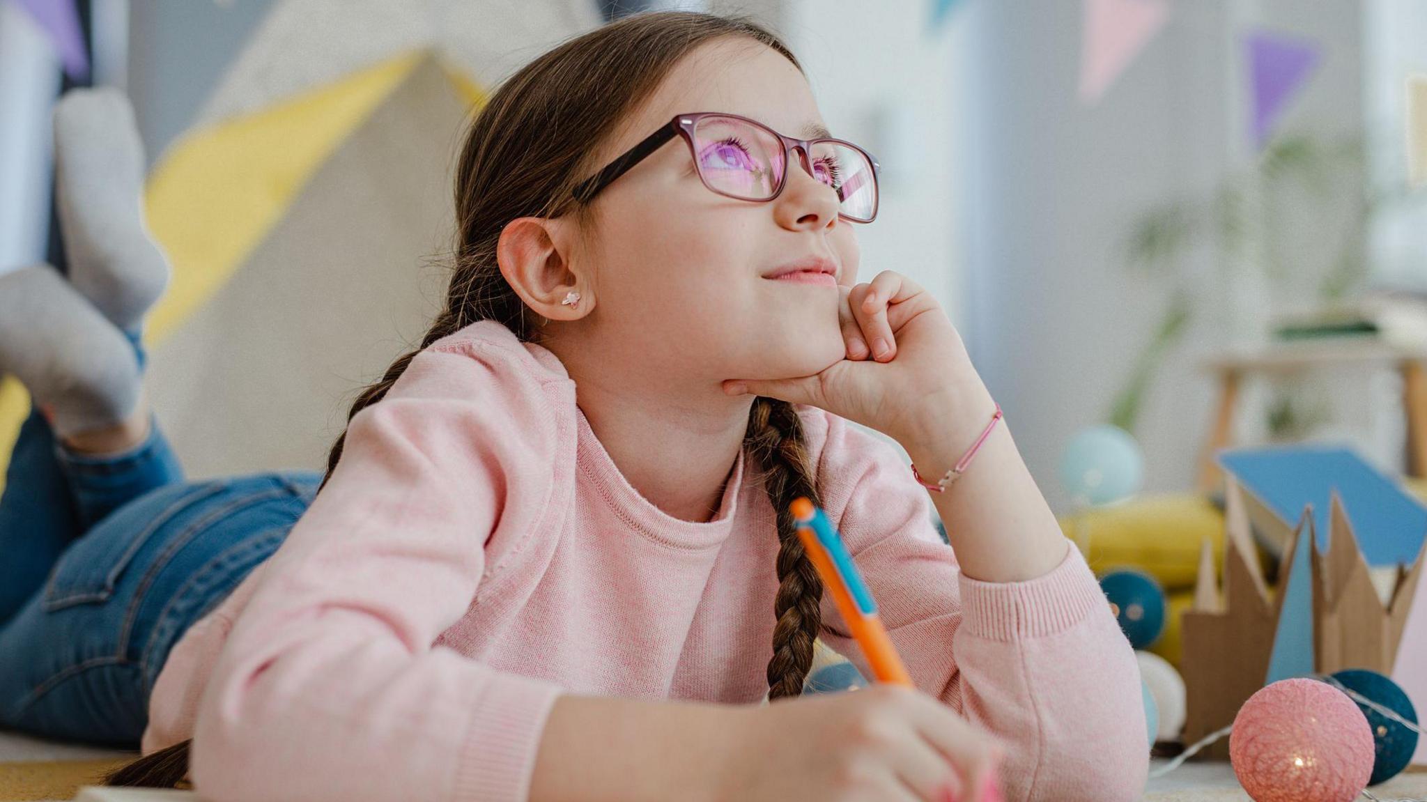 Girl holding pen and thinking. 