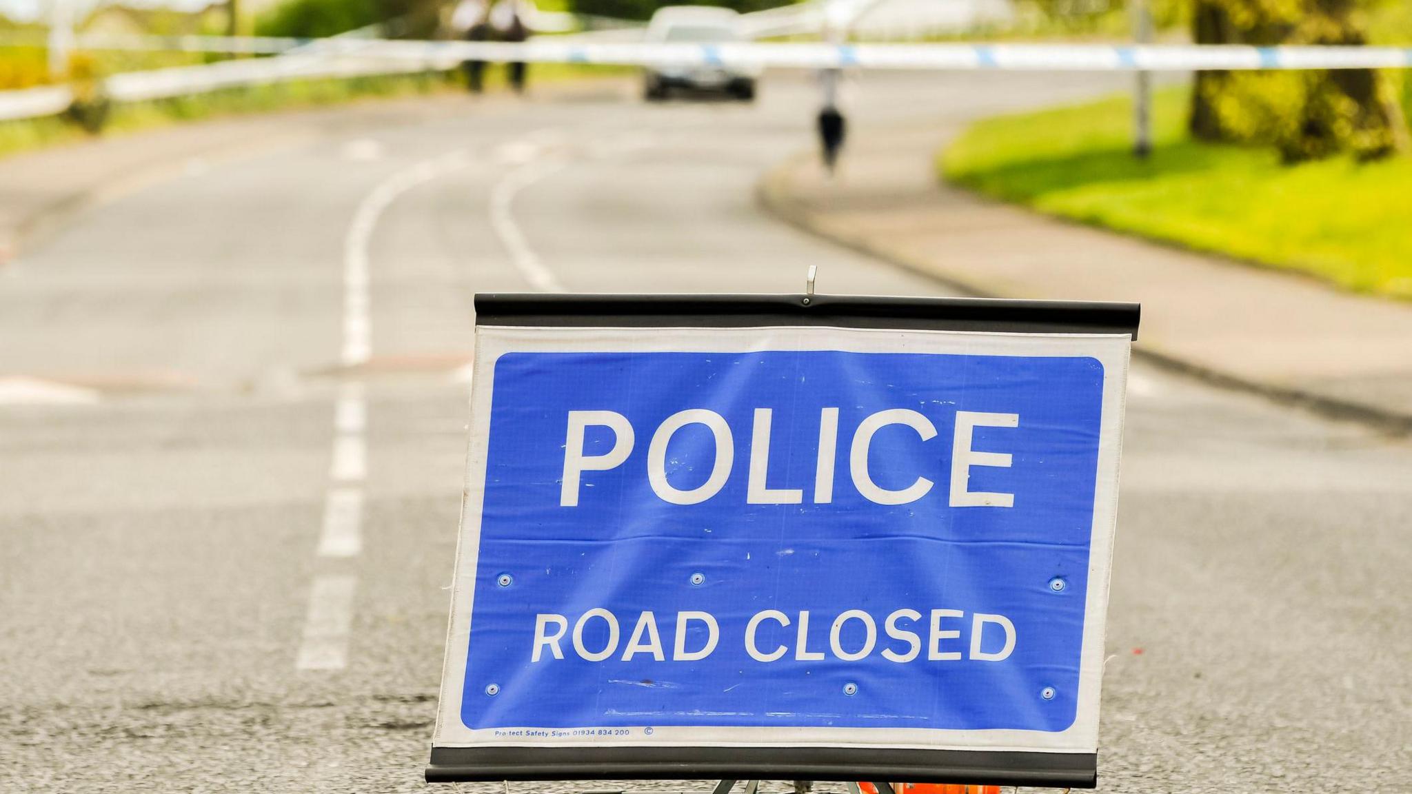 Police close a road during a security alert.
