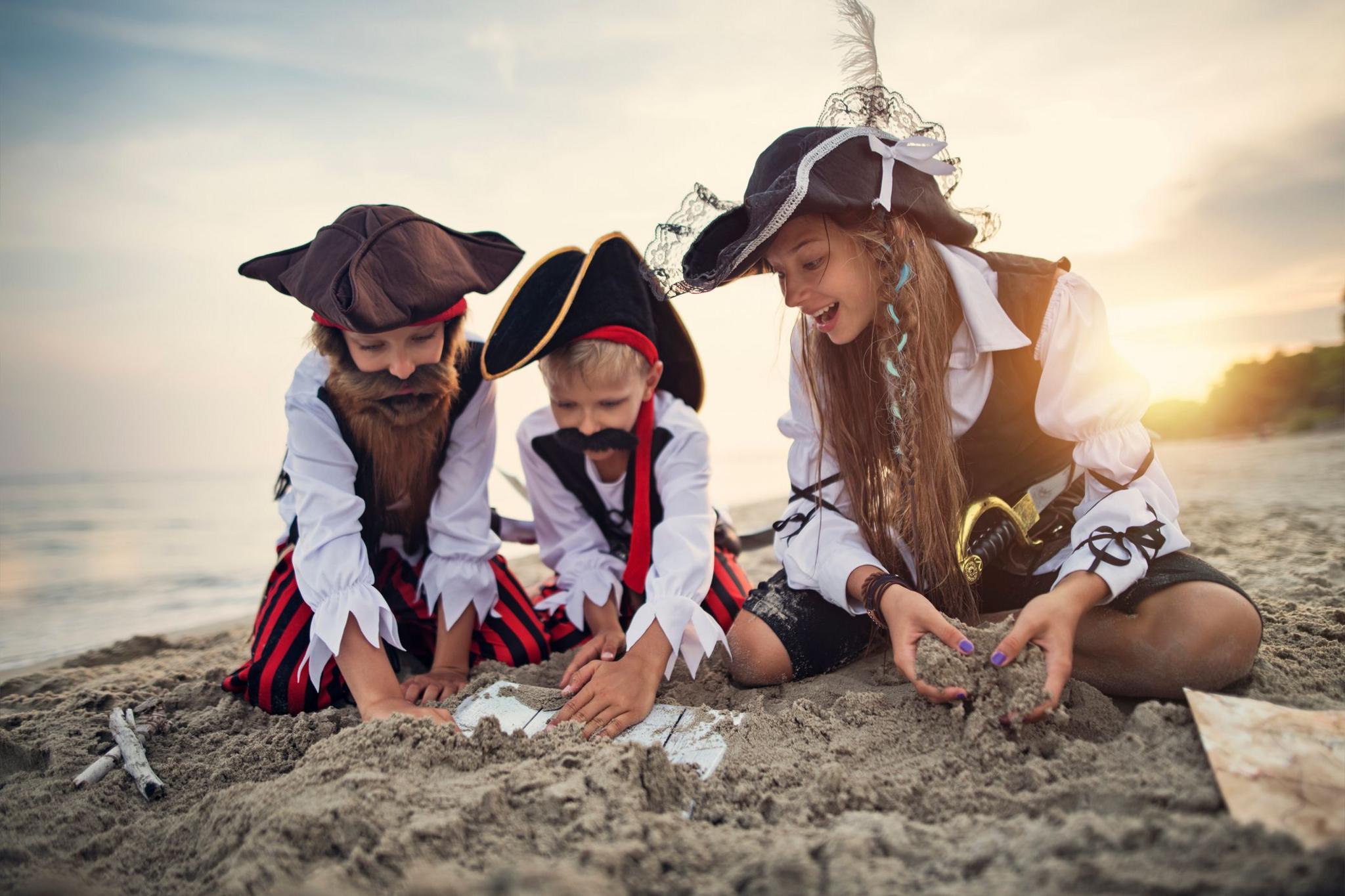 Kids dressed as pirates finding treasure