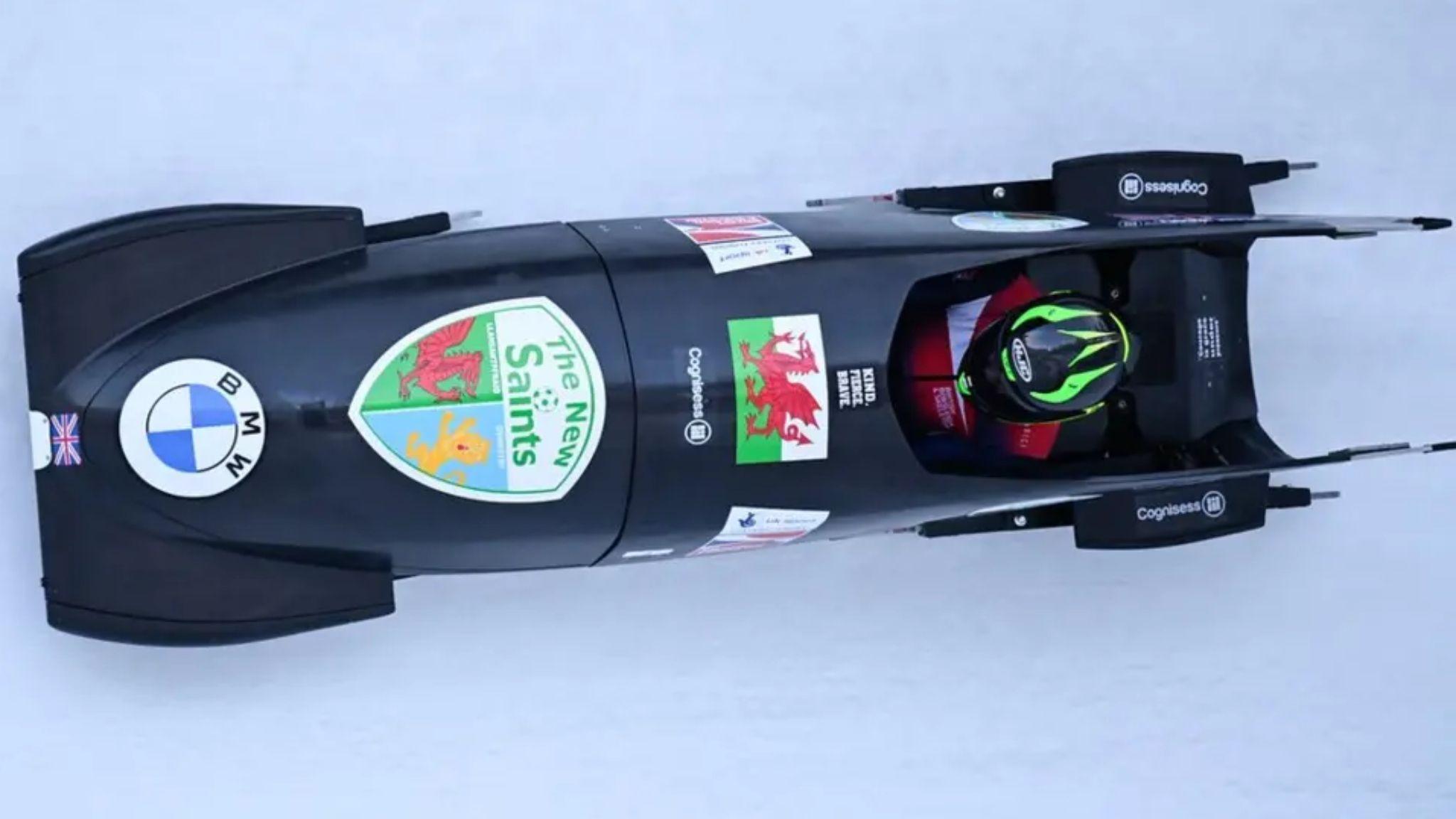 Arial view of Adele Nicoll's bobsled featuring a Welsh flag and The New Saints logo