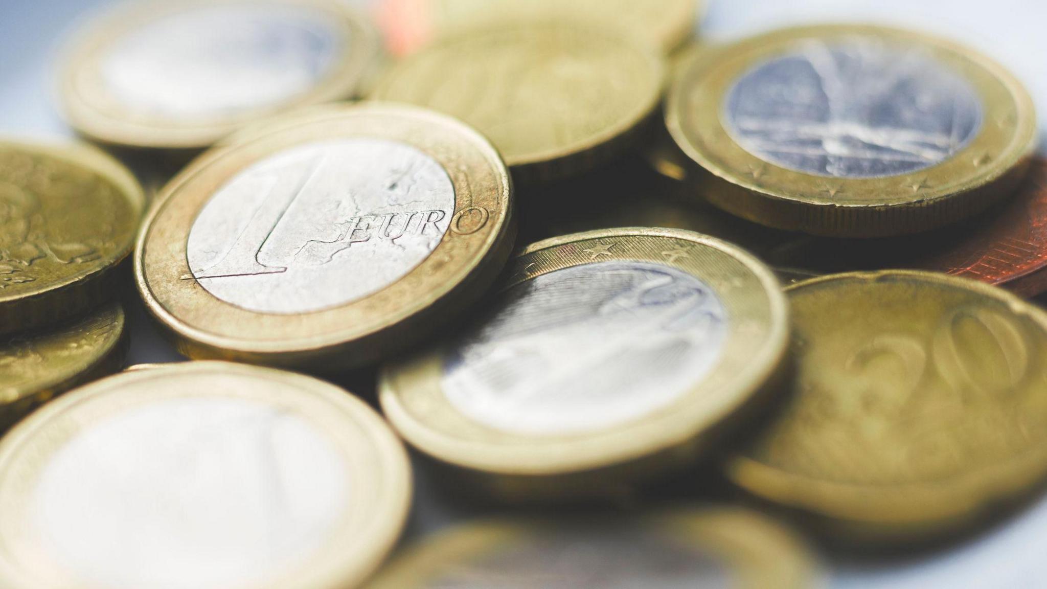 An assortment of gold and silver euro coins. 