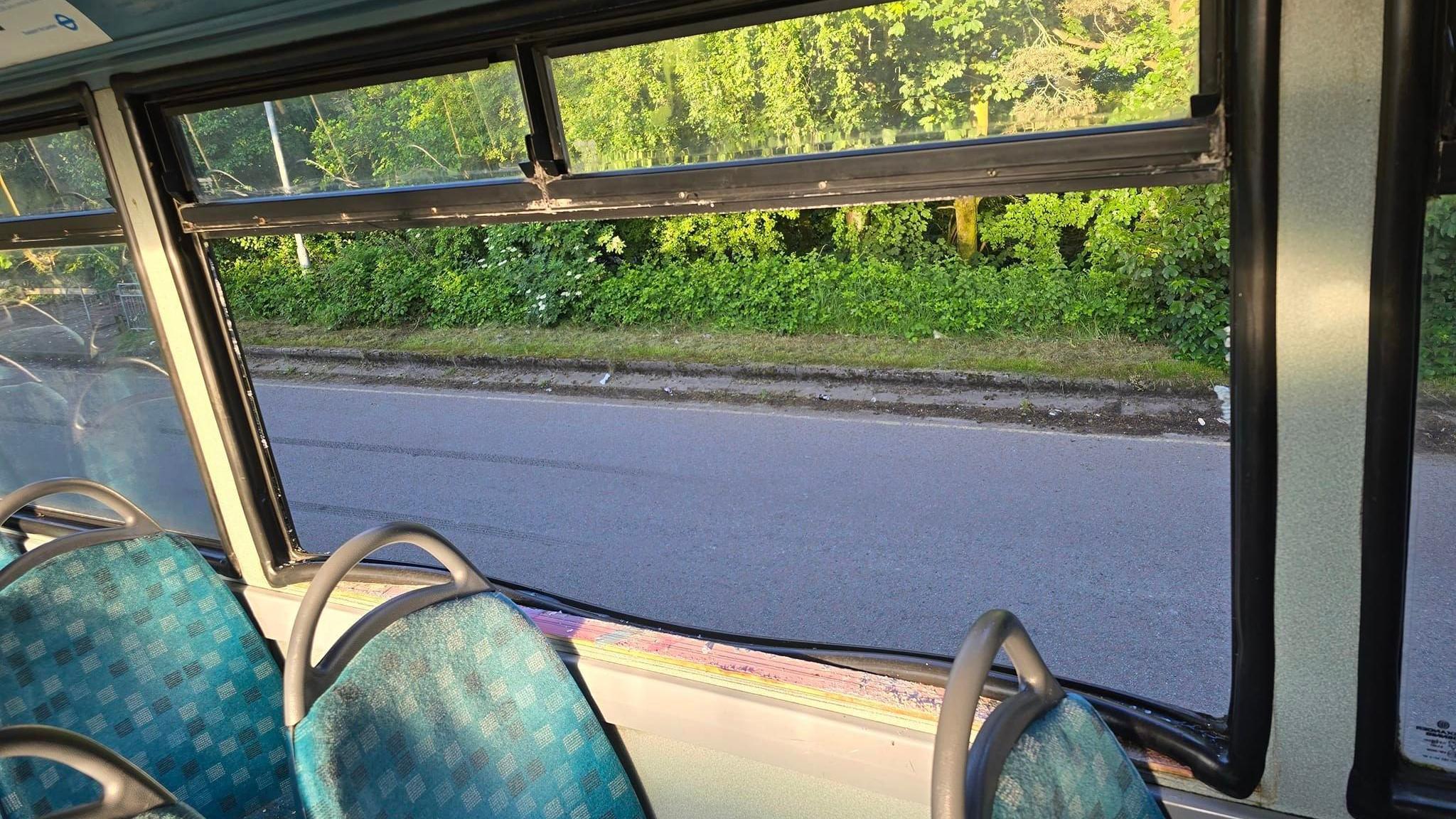 A smashed window on the bus