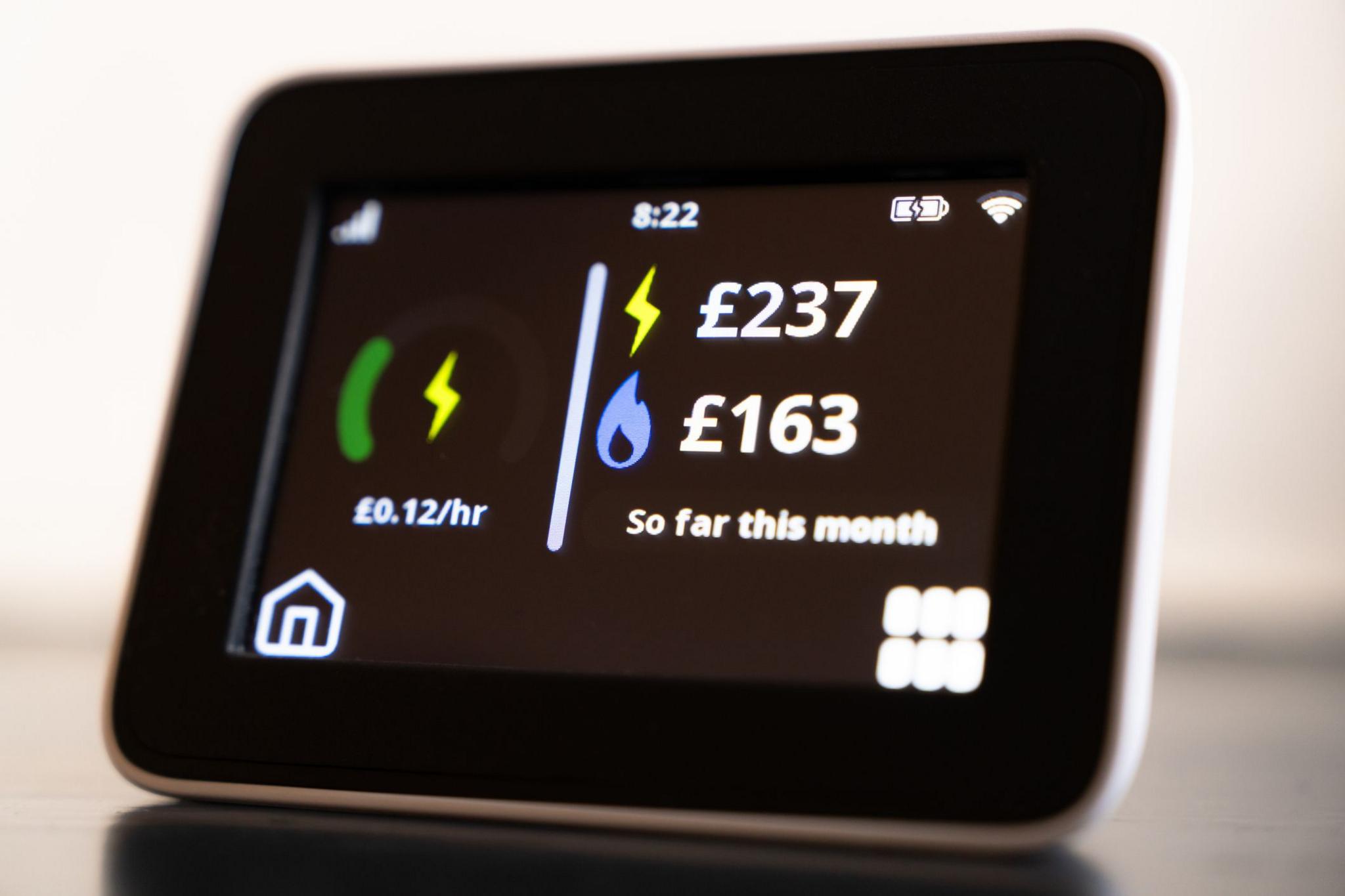 A smart meter display screen showing money spent on electricity and gas