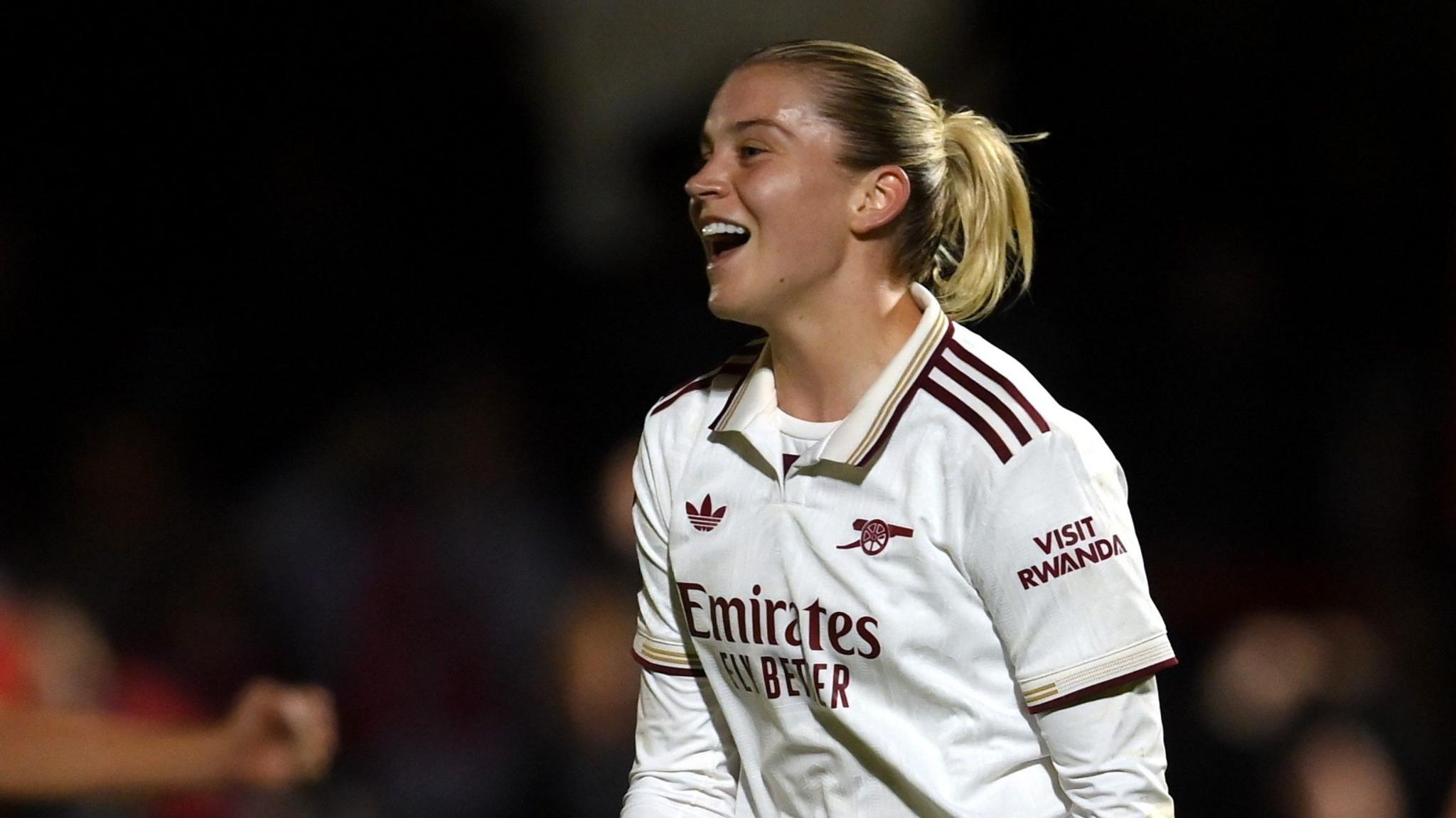 Alessia Russo looks out of the left of frame and smiles as she celebrates a goal