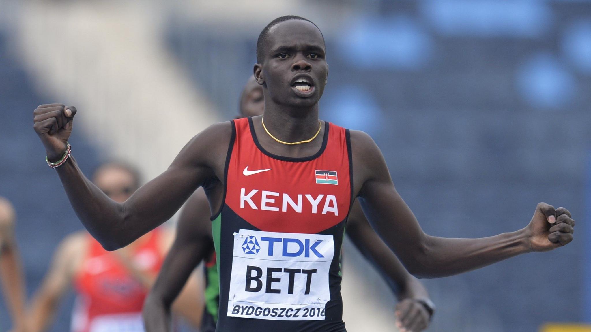 Kipyegon Bett, wearing a Kenyan athletics vest bearing his name, stretches his arms out with clenched fists after winning the 800m title at the World Under-20 Championships in 2016