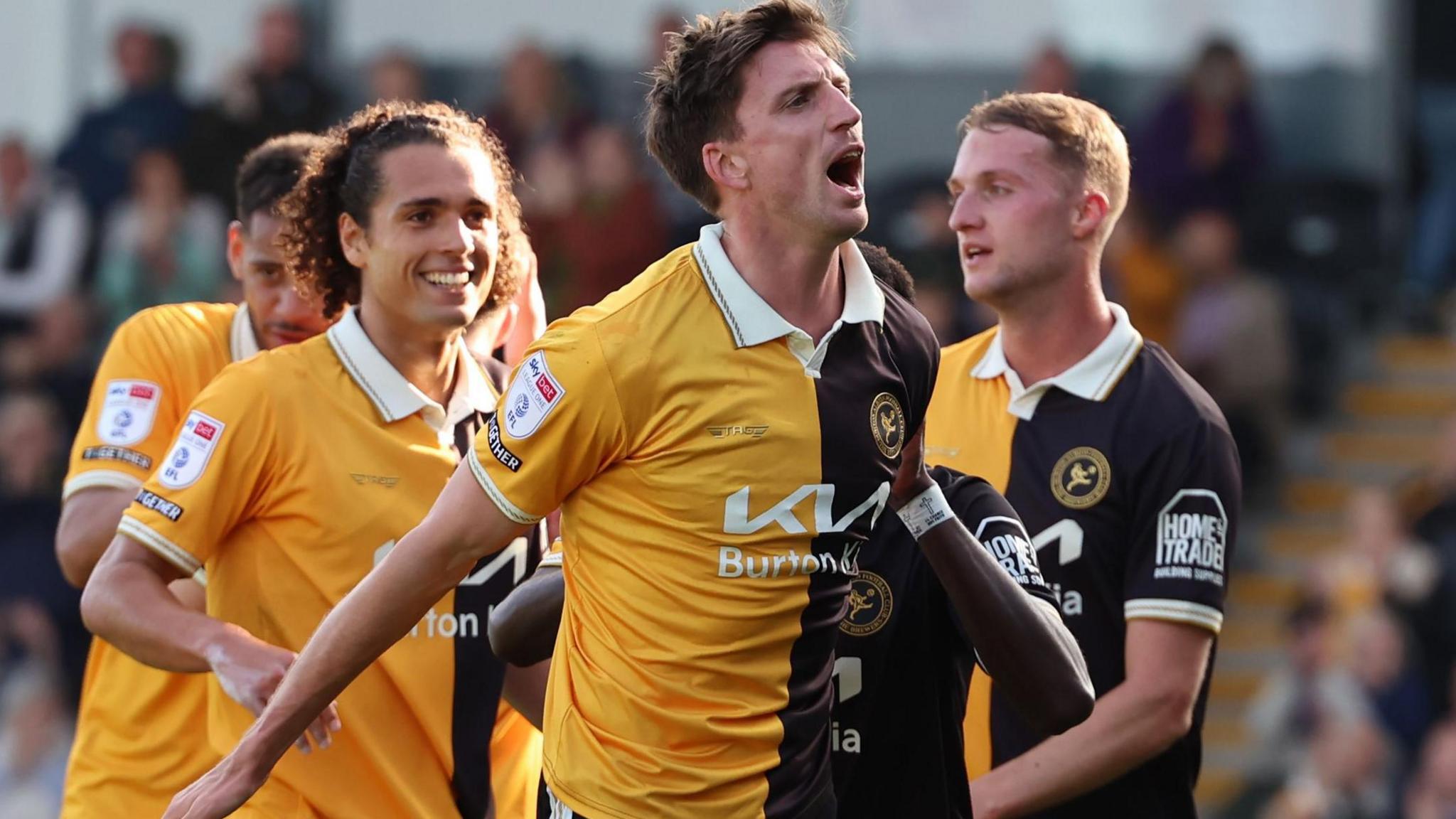 Jake Beesley celebrates in front of the Burton fans