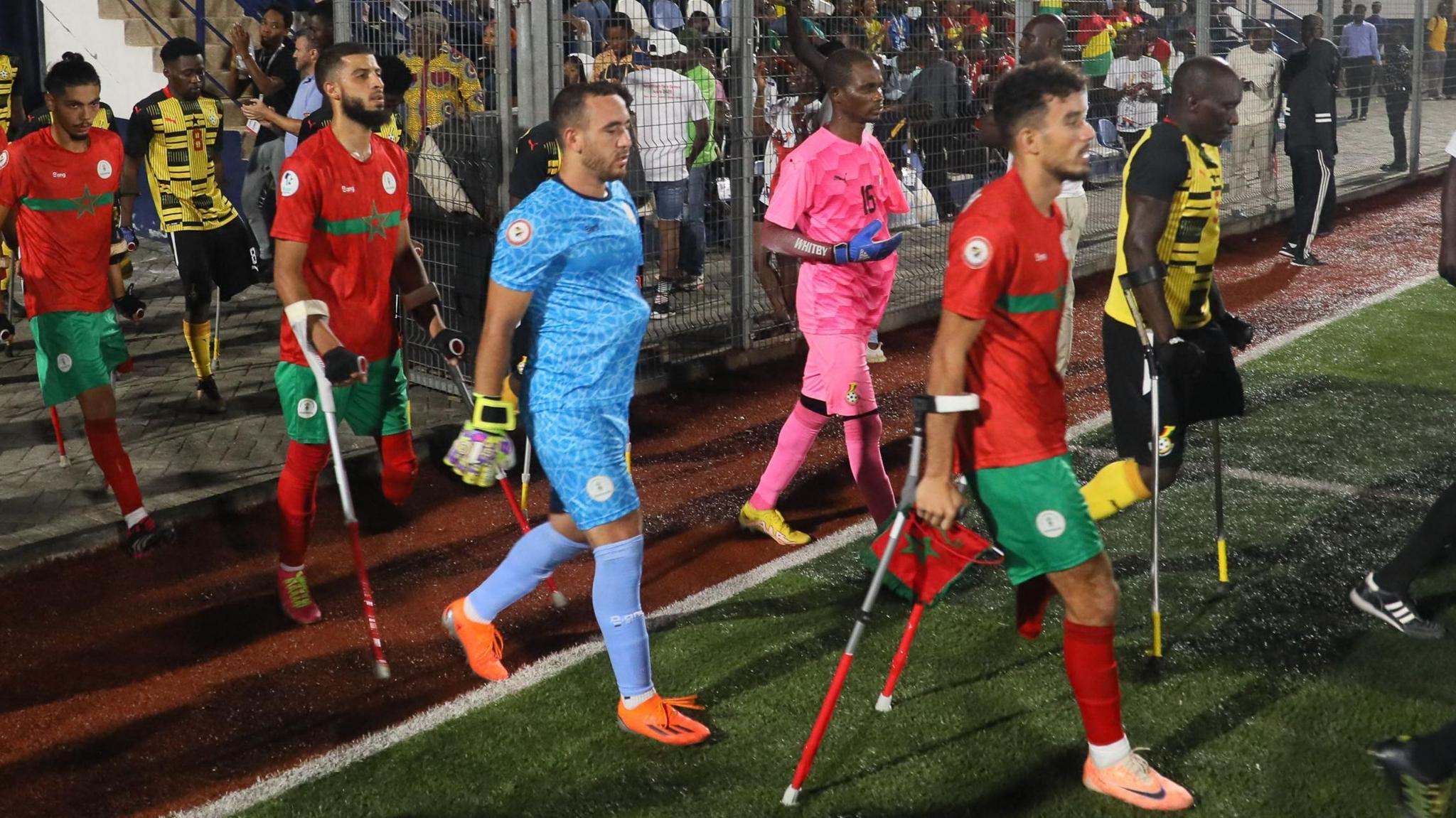 Players from Morocco and Ghana enter the pitch ahead of an amputee football match at the African Para Games