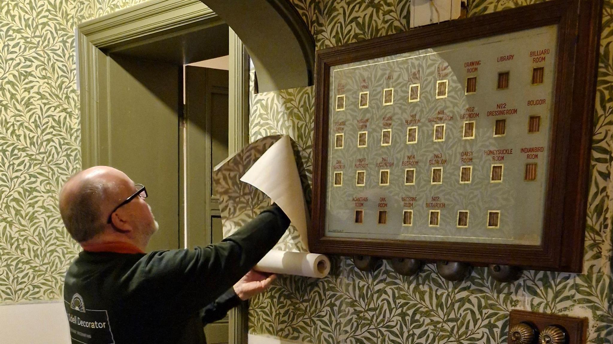 A man restoring wallpaper