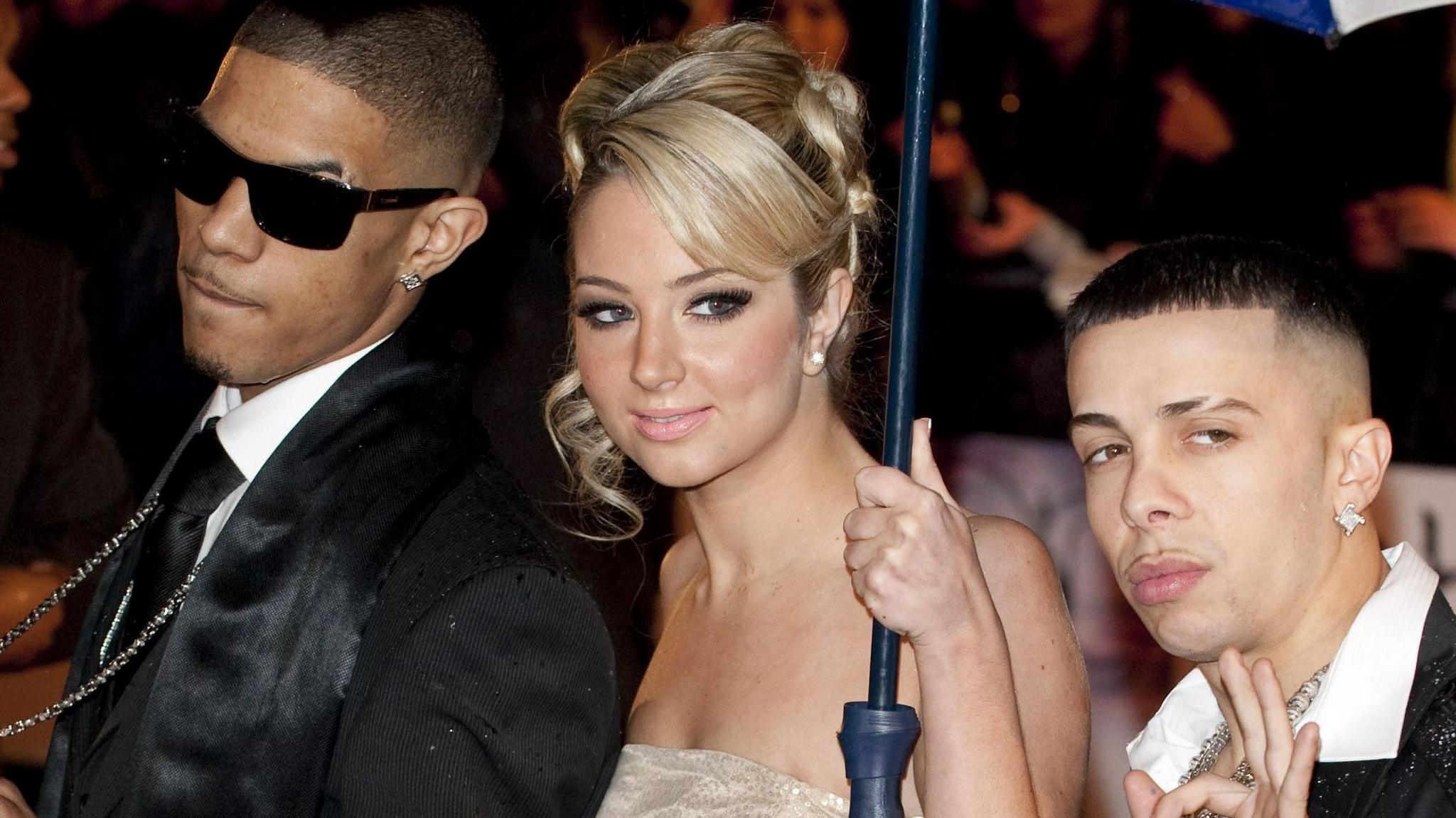 Fazer, Tulisa and Dappy From N-Dubz arriving at the 2010 Brit Awards. Tulisa (pictured centre) is holding an umbrella