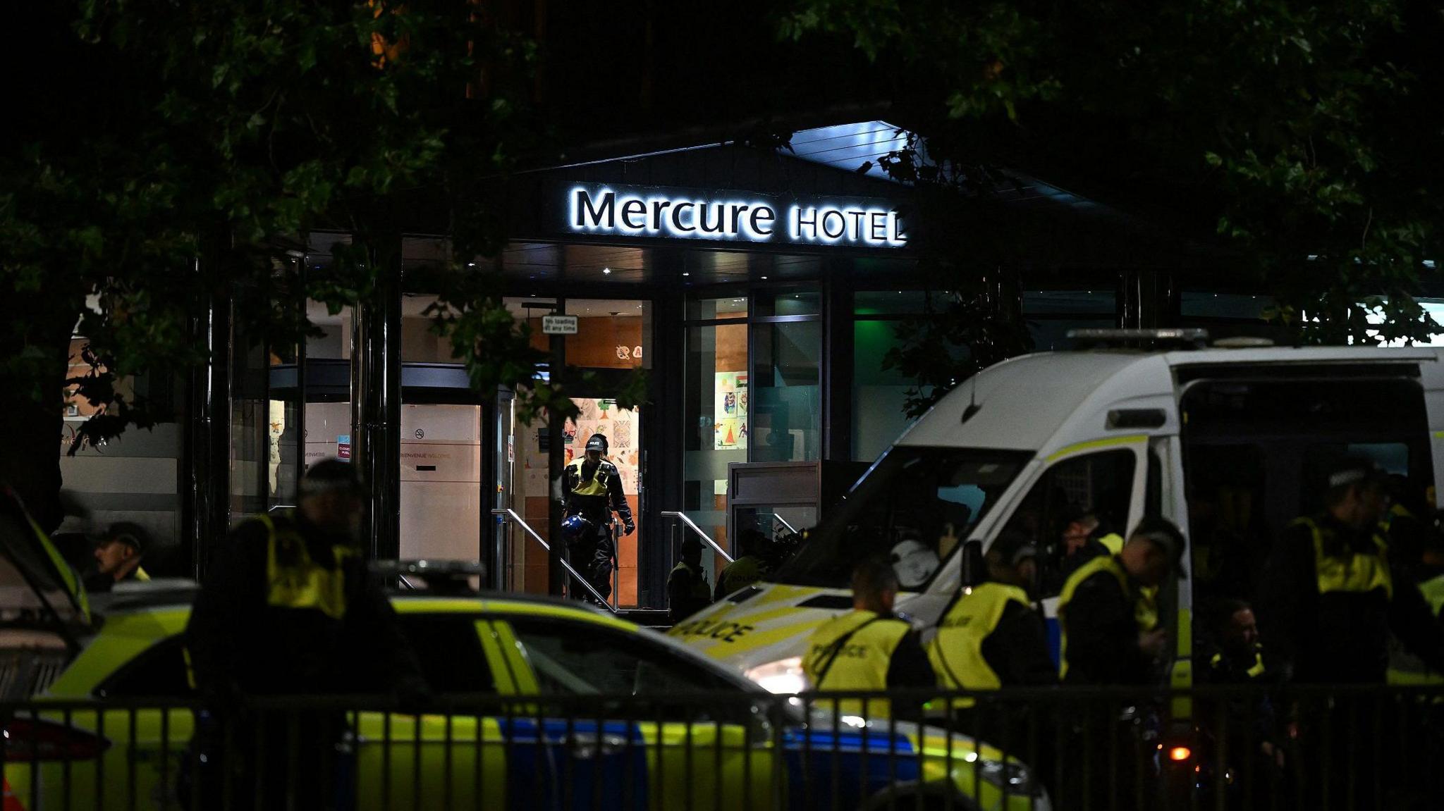 Police on foot and in riot vans outside the Mercure hotel in Bristol