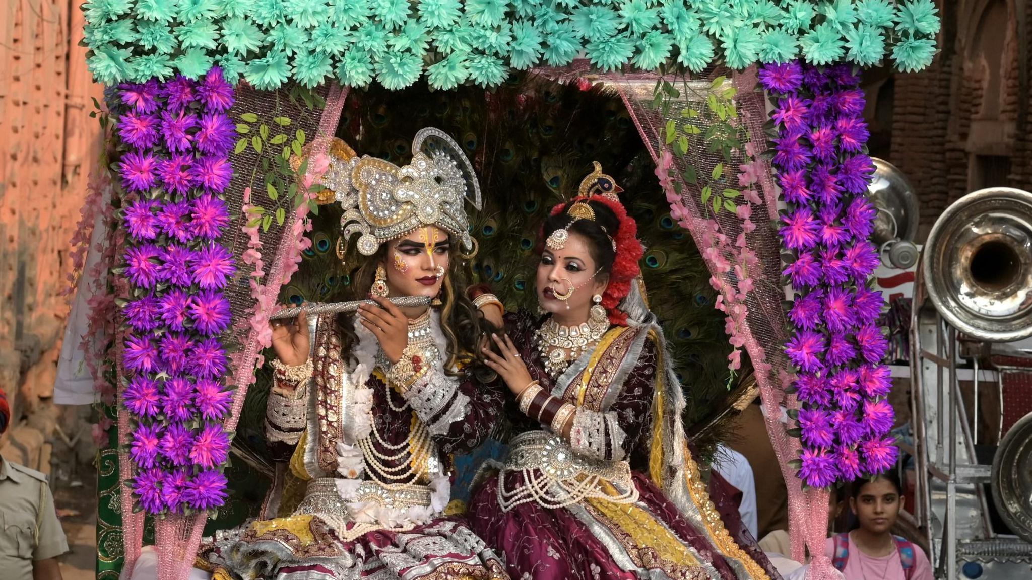Hindu devotees dressed as deities Krishna and his consort Radha take part in a religious procession to celebrate the annual Hindu festival of Maha Navami on the occasion of Dussehra in Amritsar on October 1, 2025. 