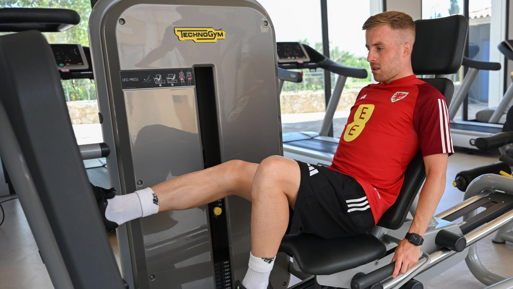 Joe Morrell using a gym machine to exercise his legs